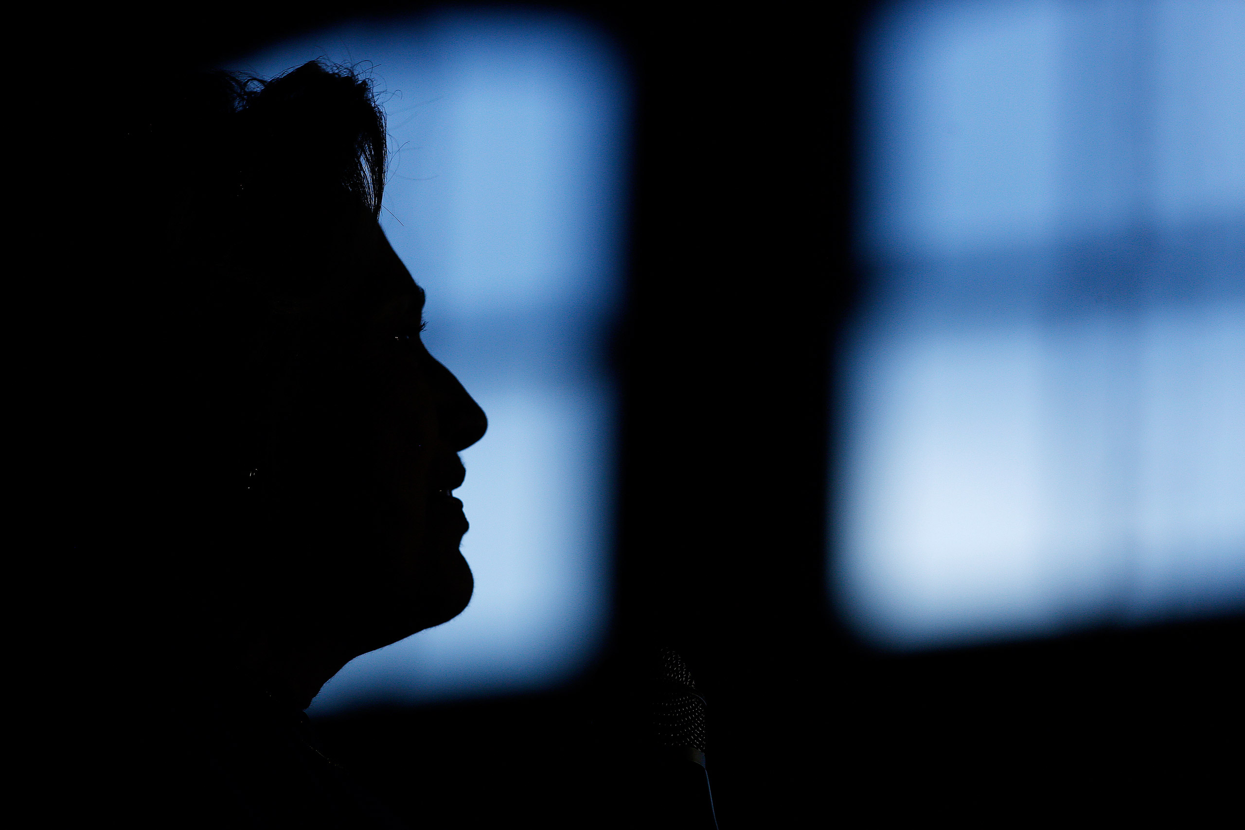 The silhouette of Hillary Clinton, former Secretary of State and 2016 Democratic presidential candidate, is seen during a campaign event in Louisville, Kentucky, U.S., on Tuesday, May 10, 2016. Clinton said she sees "a great role" for Bernie Sanders and his supporters in a "unified party," even as she said she welcomed Republicans who are not supporting presumptive nominee Donald Trump. Photographer: Luke Sharrett/Bloomberg via Getty Images