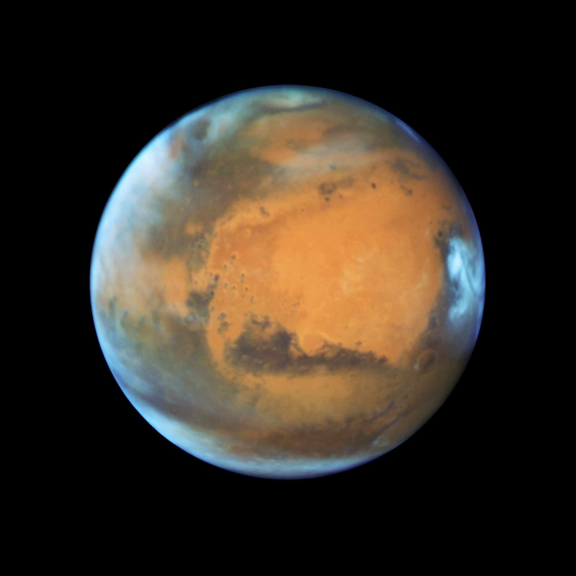 Bright, frosty polar caps, and clouds above a vivid, rust-colored landscape reveal Mars as a dynamic seasonal planet on May 12, 2016.