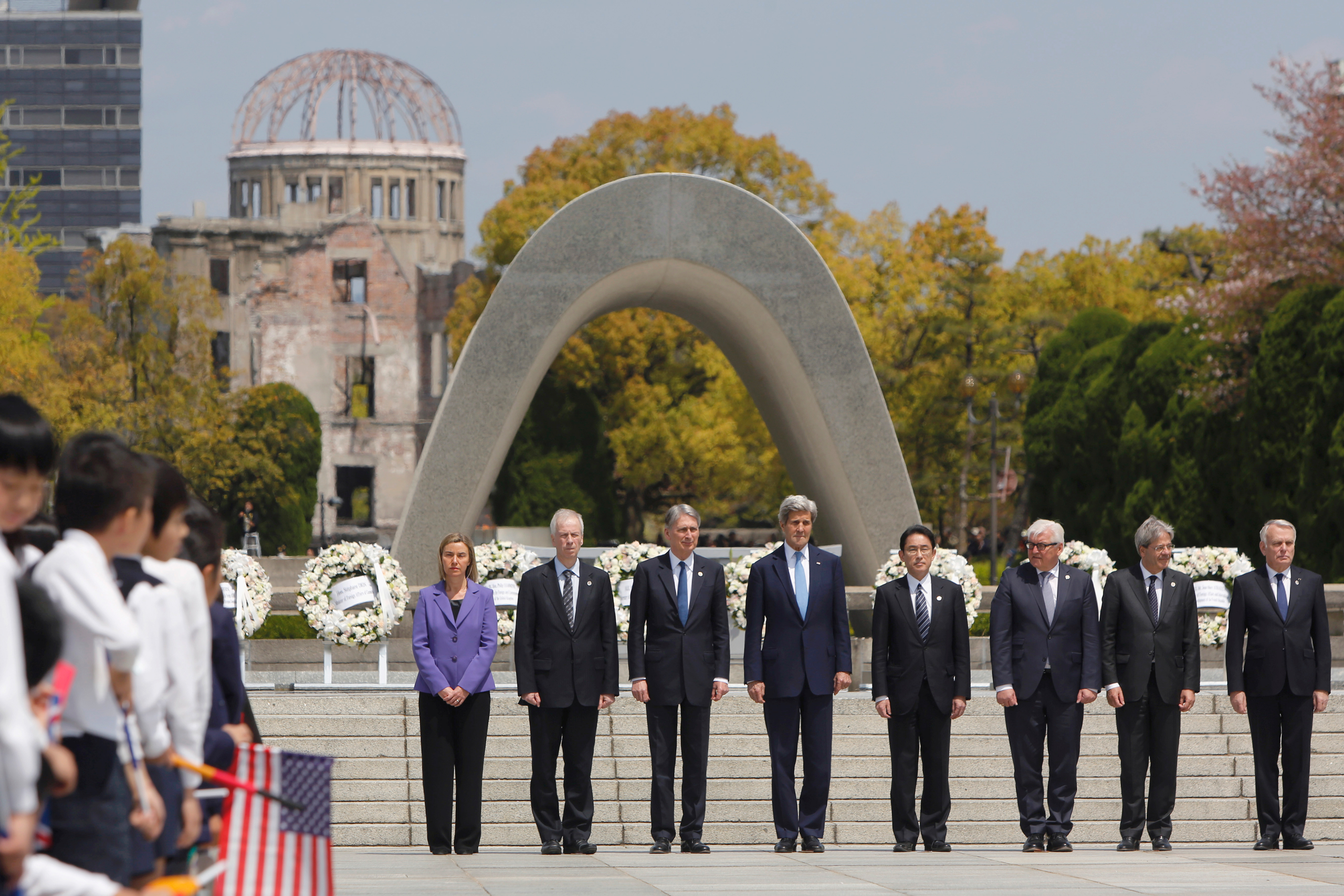 G7 foreign ministers stand together after placing wreaths at the cenotaph at Hiroshima Peace Memorial Park in Hiroshima, western Japan on April 11, 2016. Pictured from left are E.U. High Representative for Foreign Affairs Federica Mogherini, Canada's Foreign Minister Stephane Dion, Britain's Foreign Minister Philip Hammond, U.S. Secretary of State John Kerry, Japan's Foreign Minister Fumio Kishida, Germany's Foreign Minister Frank-Walter Steinmeier, Italy's Foreign Minister Paolo Gentiloni and France's Foreign Minister Jean-Marc Ayrault. (Jonathan Ernst—Press Pool/AP)