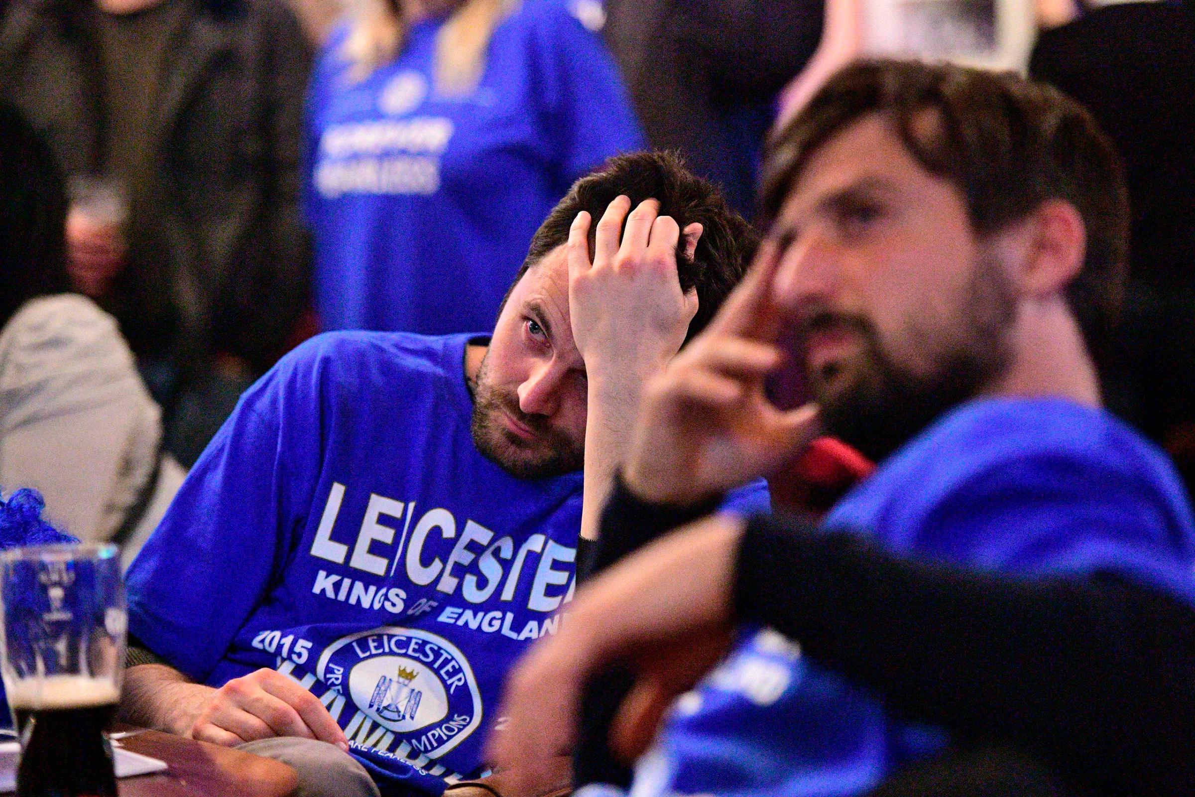 A Leicester City fan reacts as he watches after Tottenham scored their second goal in the English Premier League football match between Chelsea and Tottenham Hotspur in a pub in central Leicester, eastern England, on May 2, 2016.