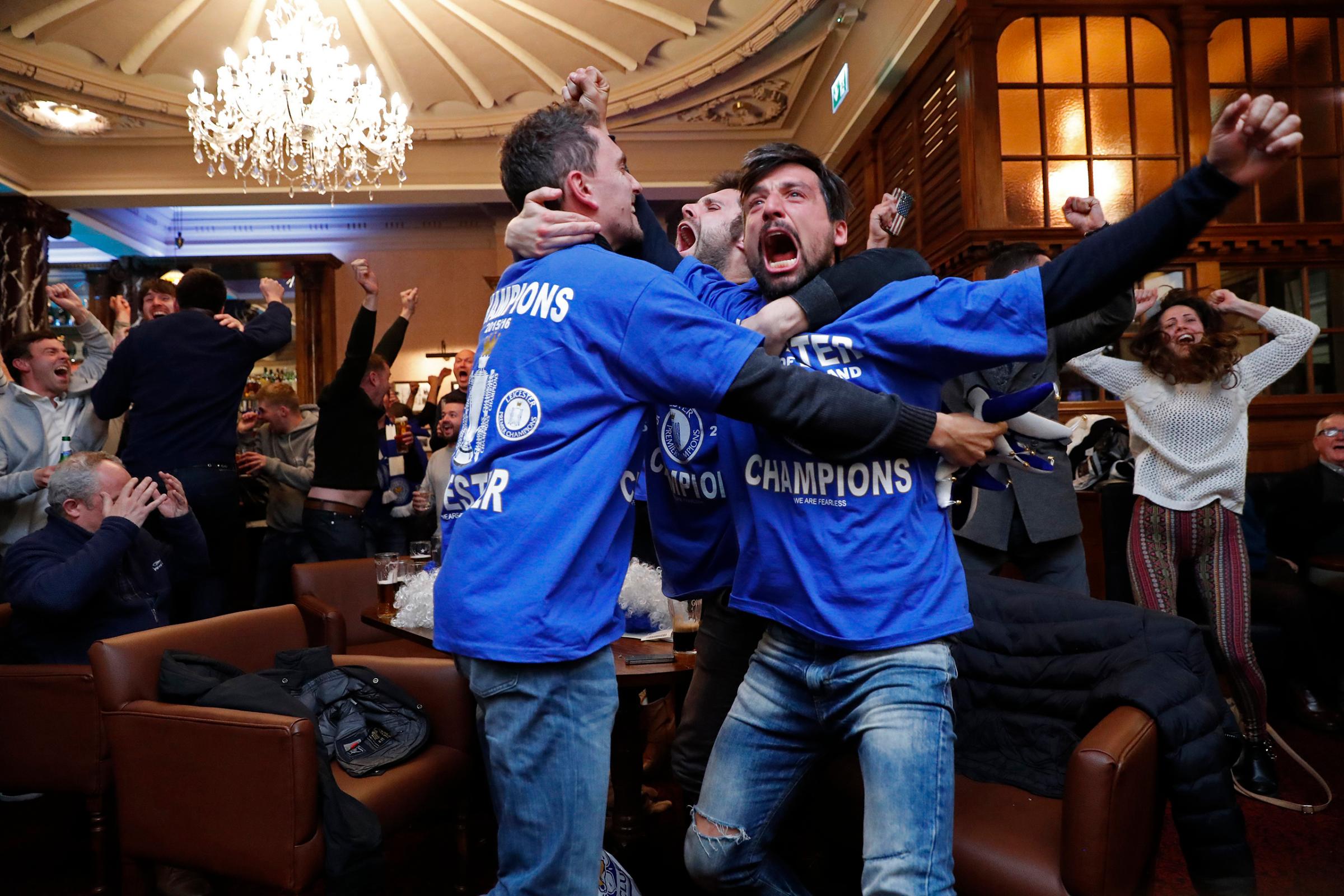Leicester City fans celebrate after Chelsea's second goal against Tottenham Hotspur at a pub in Leicester, eastern England, May 2, 2016.