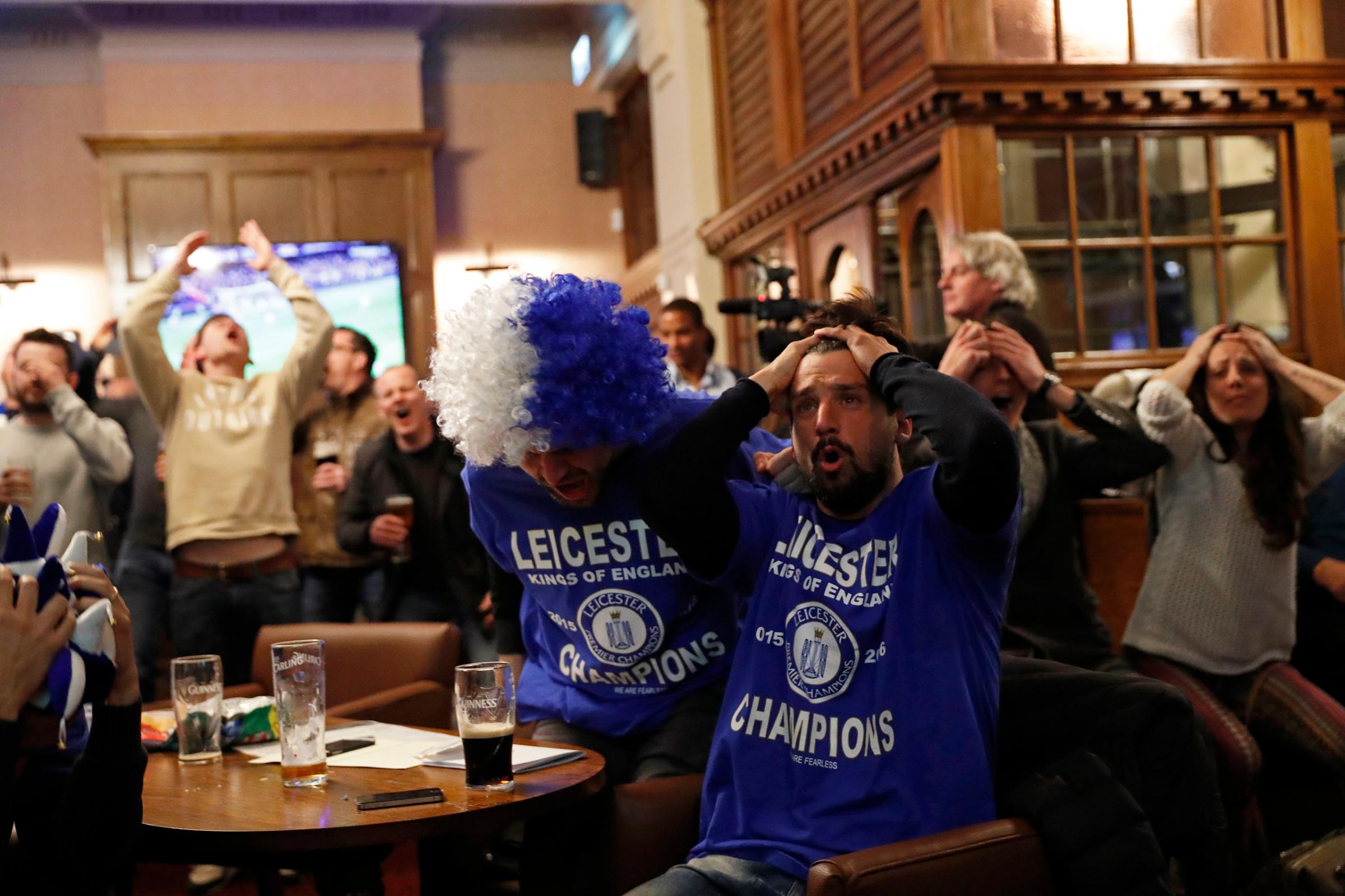 Leicester City fans watch the English Premier League match between Chelsea and Tottenham Hotspur at a pub in Leicester, eastern England, May 2, 2016.