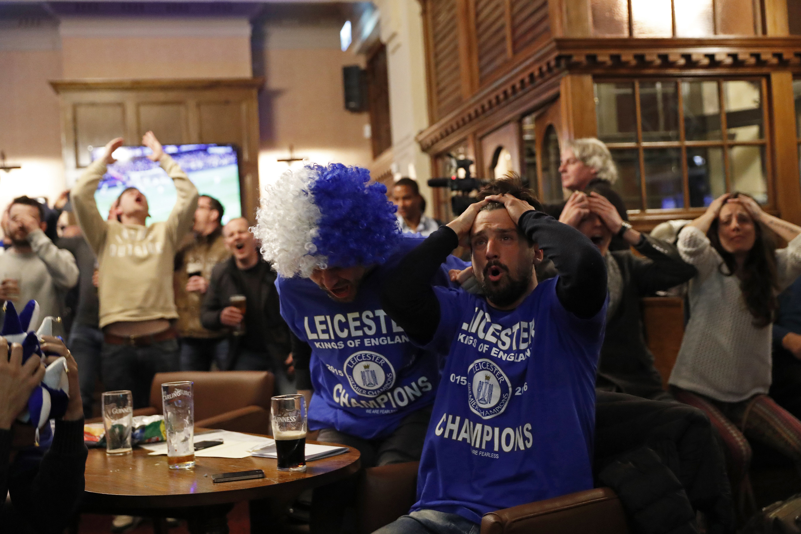 Leicester City fans watch the English Premier League match between Chelsea and Tottenham Hotspur at a pub in Leicester, eastern England, May 2, 2016. (Eddie Keogh—Reuters)