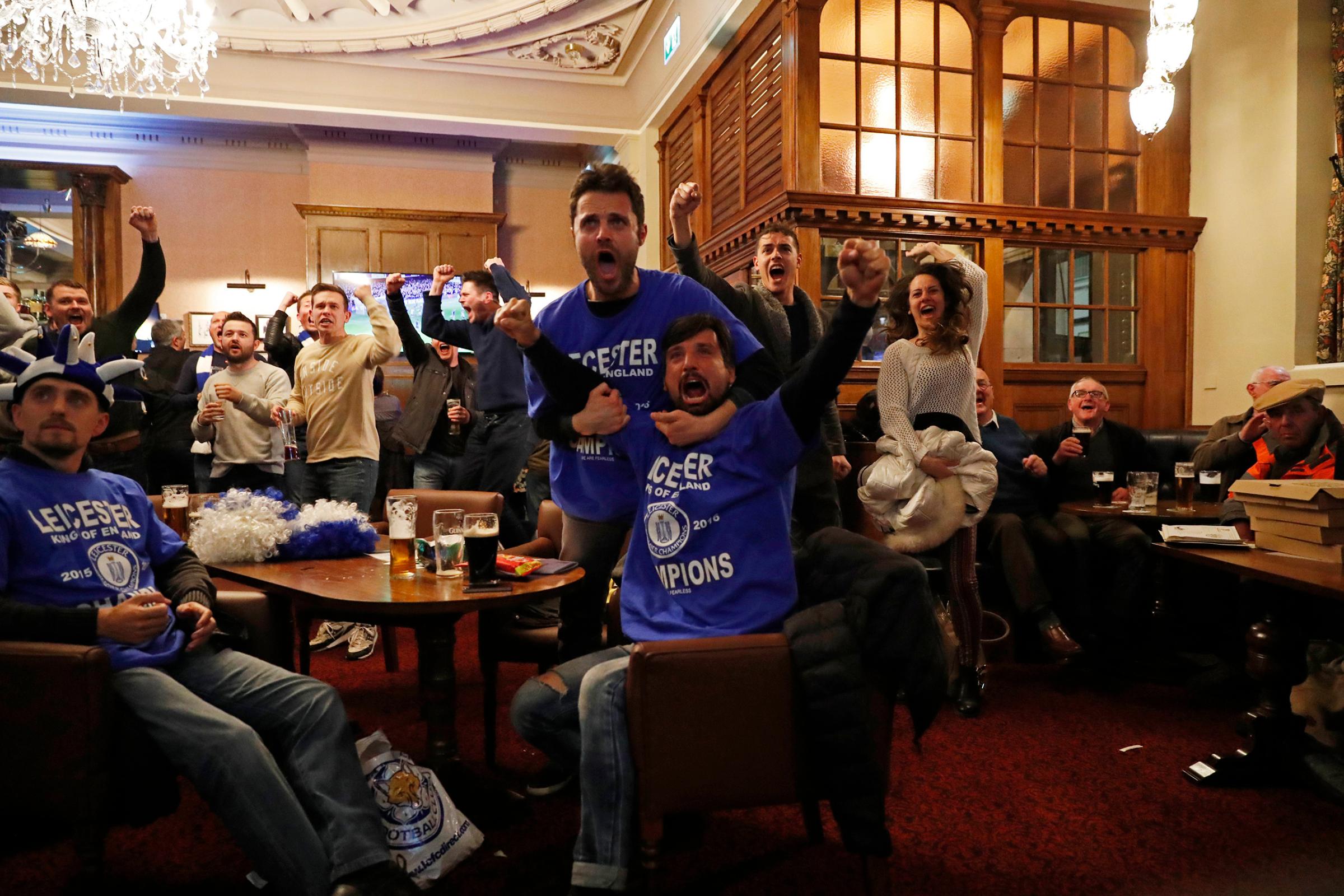 Leicester City fans celebrate after Chelsea's first goal against Tottenham Hotspur at a pub in Leicester, eastern England, May 2, 2016.