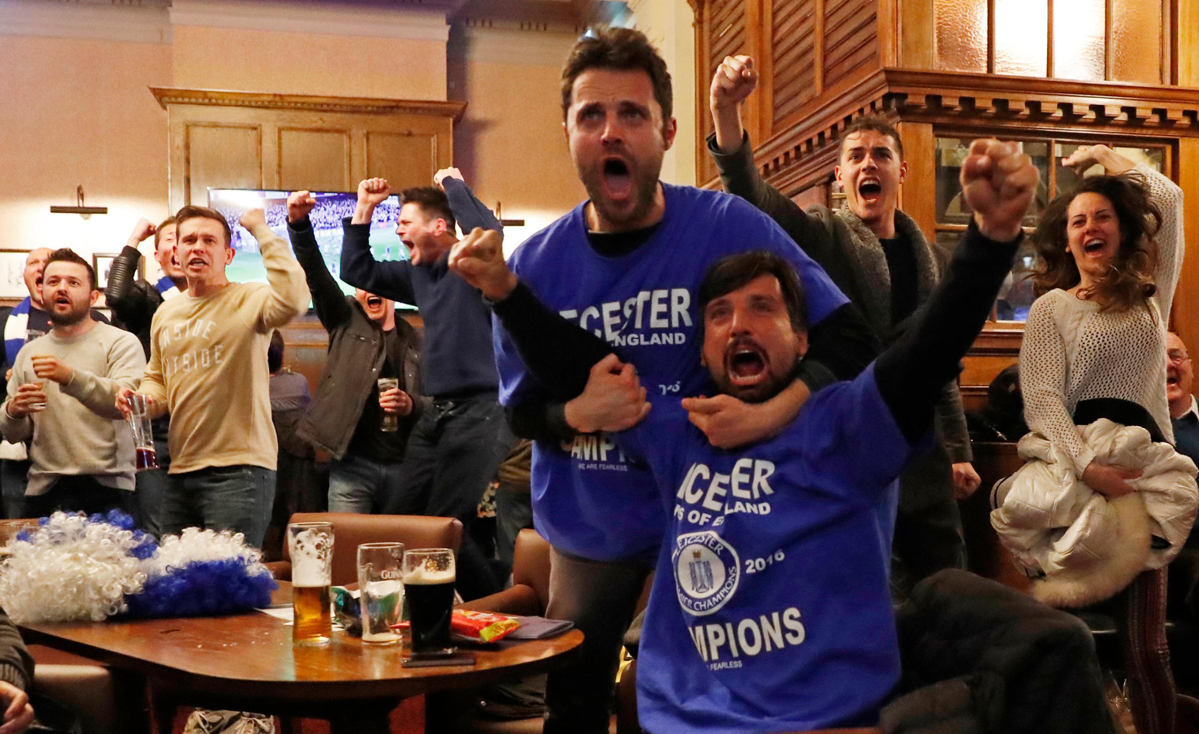 Leicester City fans celebrate after Chelsea's first goal against Tottenham Hotspur at a pub in Leicester, eastern England, May 2, 2016.