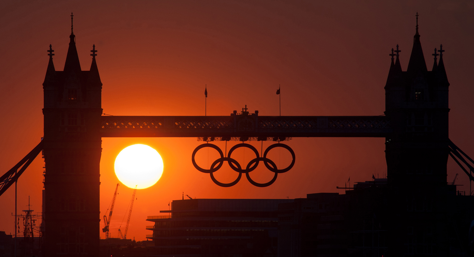 The sun sets behind Tower Bridge and the Olympic Rings in Central London during the 2012 London Olympic Games. (Will Oliver—AFP/Getty Images)