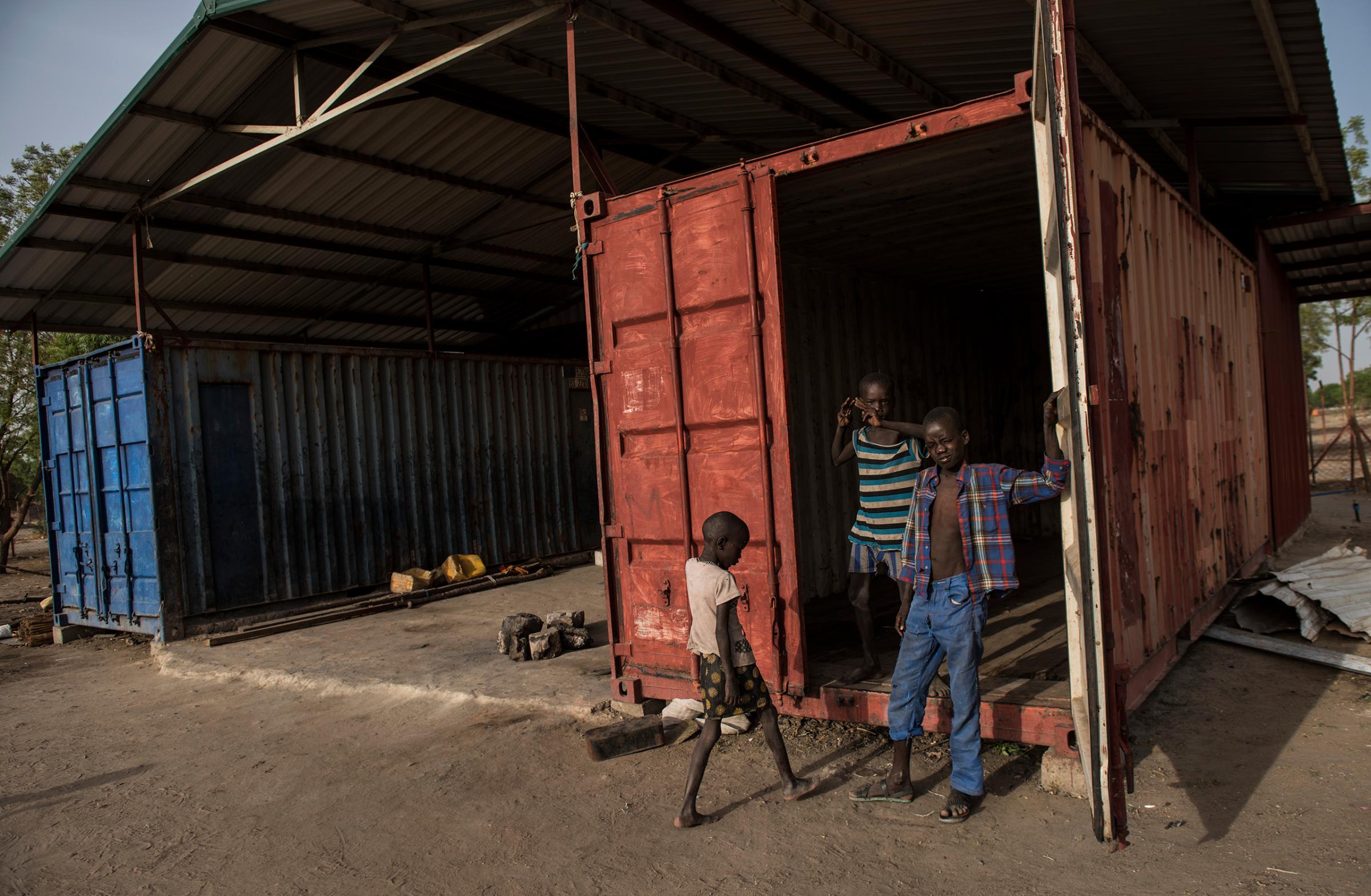 South Sudanese children play on March 20, 2016, in the containers on the church compound where, in October 2015, more than 50 men were locked inside a container and died. One 13-year-old boy survived.