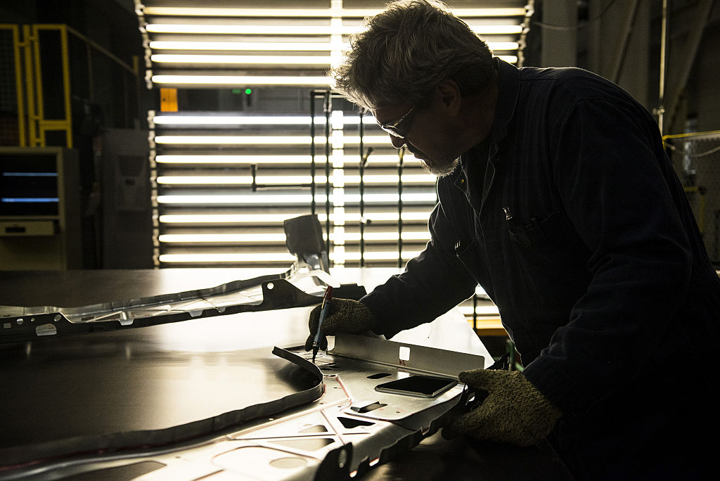 An employee inspects the quality of fenders during production, in Arlington, Texas, on March 10, 2016. (Matthew Busch—Bloomberg/Getty Images)