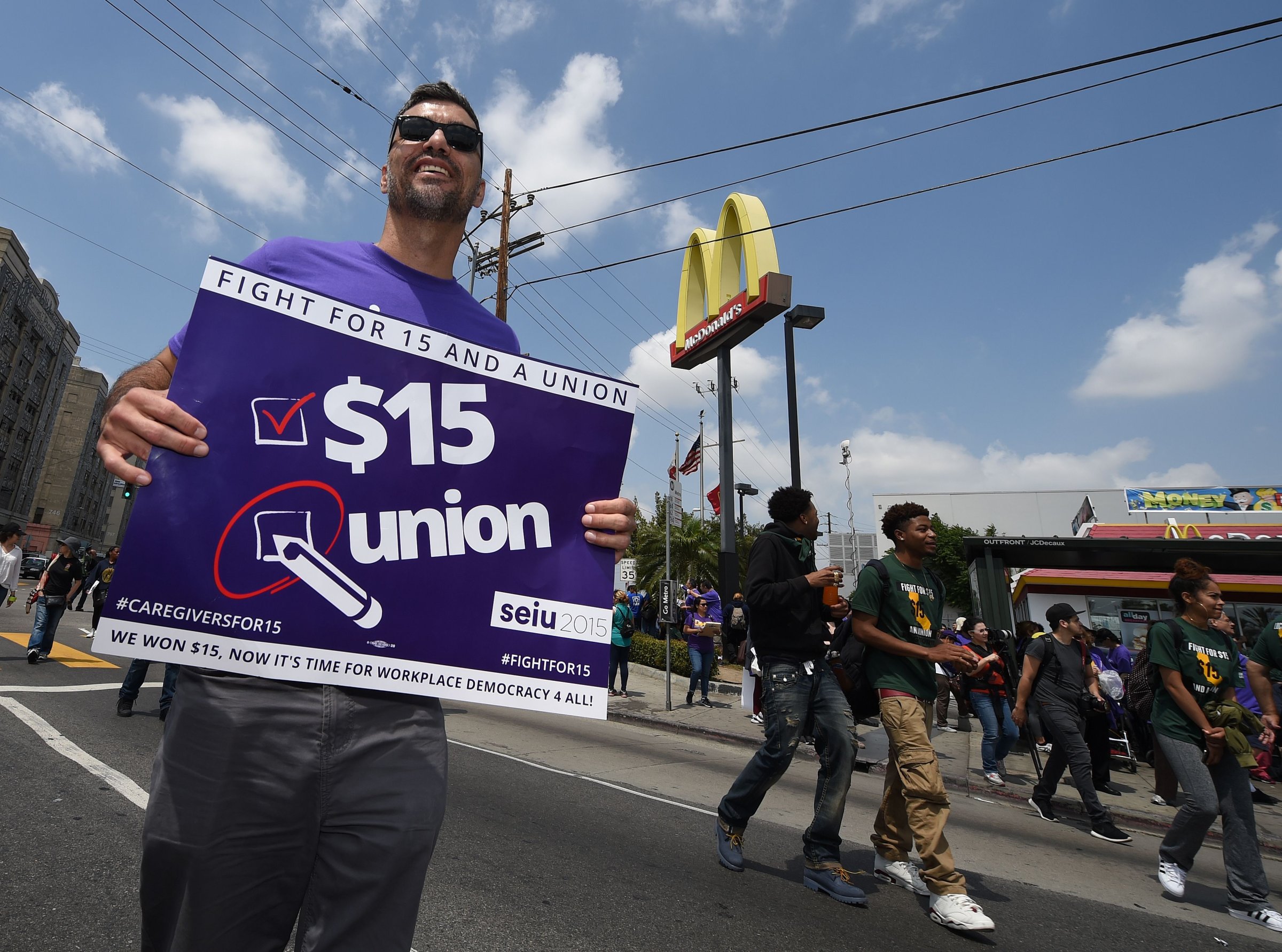 Workers from the fast-food, home care and child care industries protest outside a McDonald's restaurant as they demand a nationwide $15-an-hour minimum wage, in Los Angeles, California on April 14, 2016.