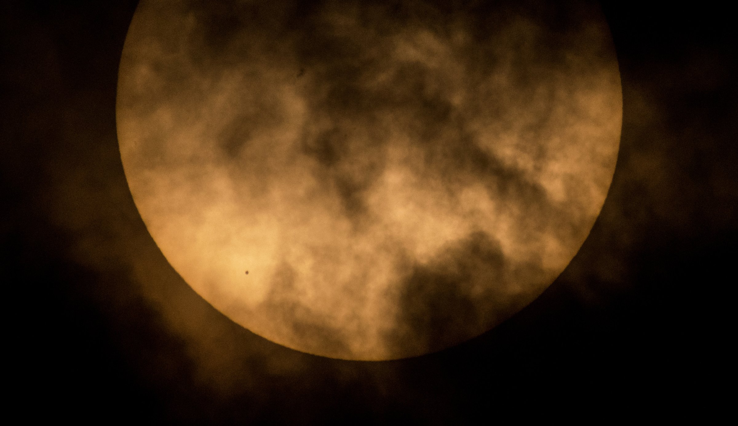 The planet Mercury is seen in silhouette, lower left, as it transits across the face of the sun in this photo taken from NASA Headquarters in Washington, DC., May 9, 2016.