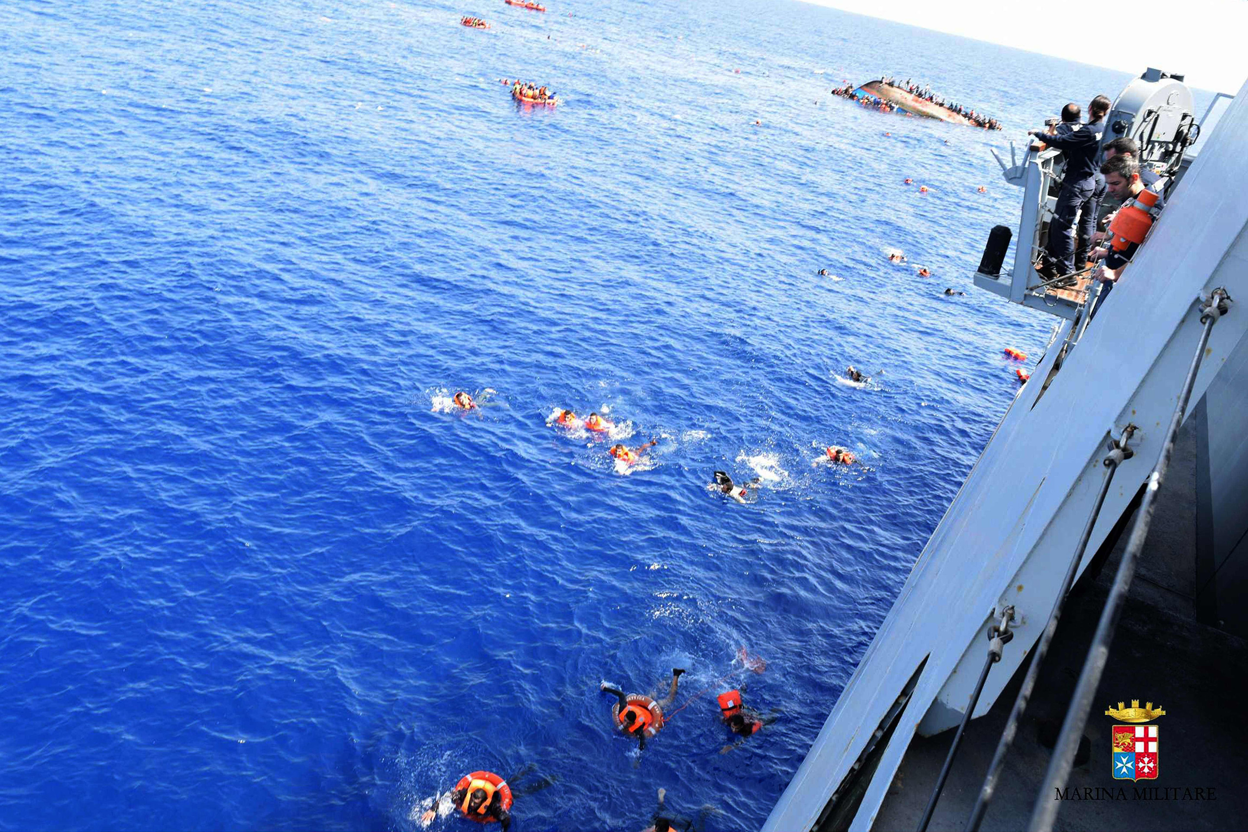 Migrants swimming towards the Italian navy’s Bettica patrol boat, that spotted the overcrowded boat in precarious conditions off the coast of Libya. (Italian Navy/AFP/Getty Images)