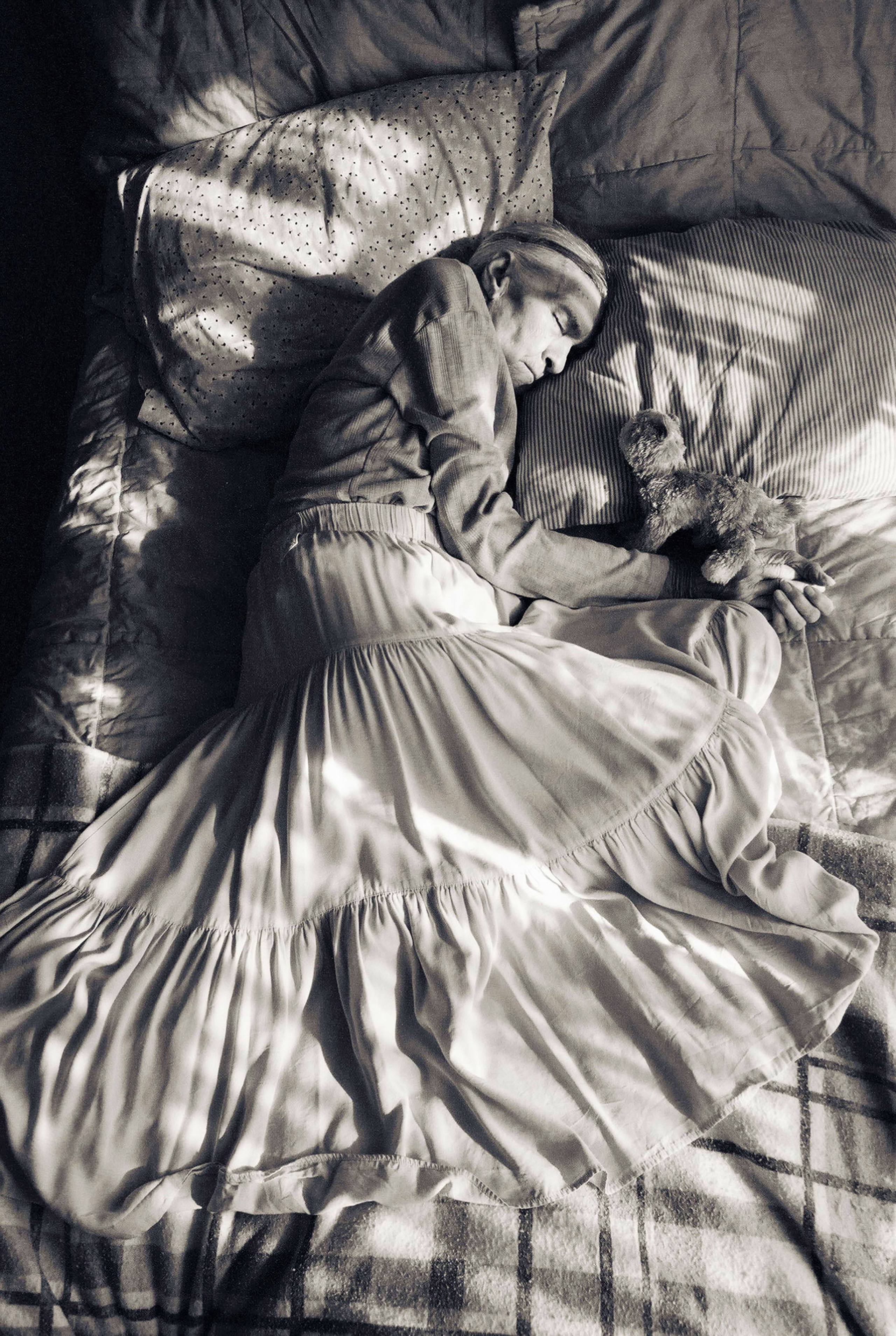 Madje Steber, 87, takes an afternoon nap in her bed at Midtown Manor, an assisted living home in Hollywood, Fl. From the series Madje has dementia. (MAGGIE STEBER)
