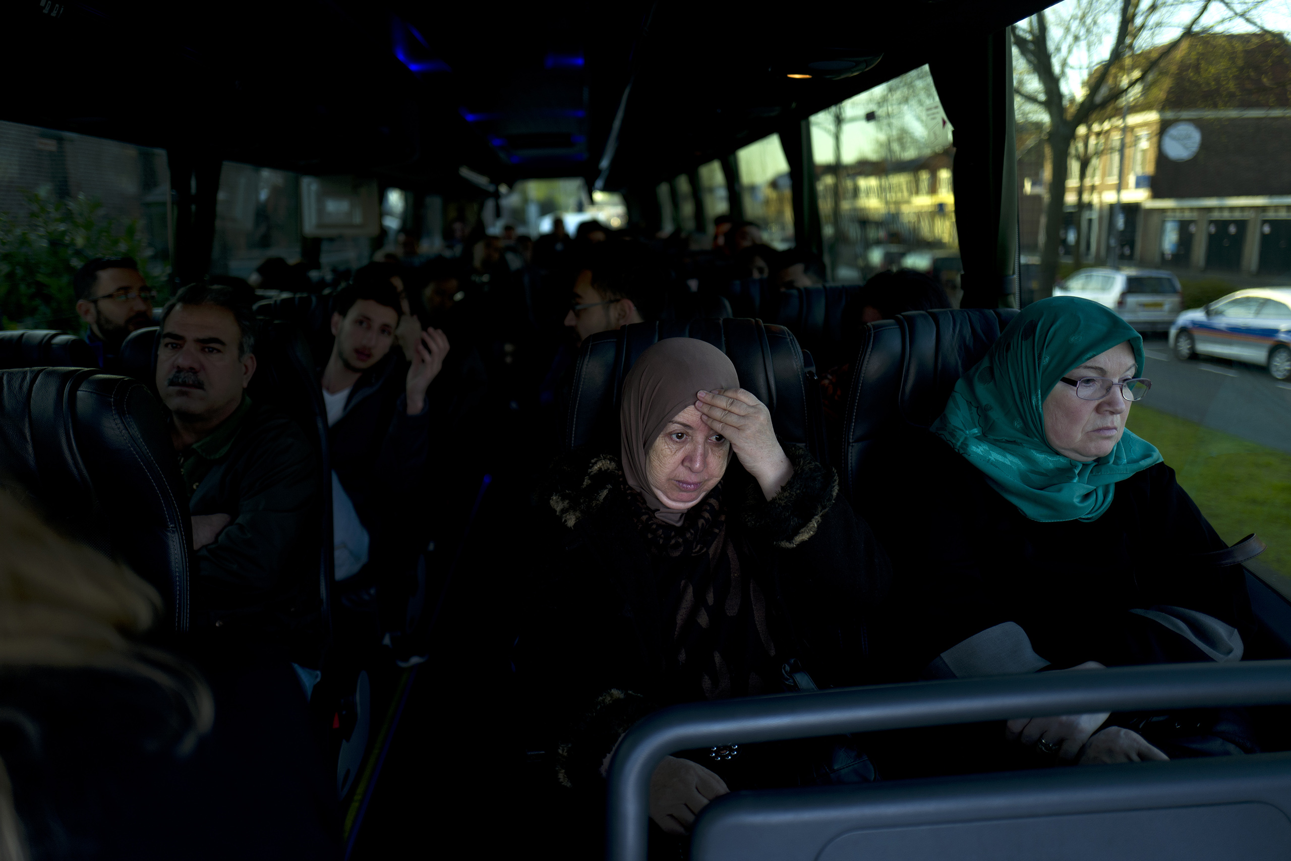 Iraqi refugee Fatima Hussein, 65, reacts while she and others wait in a bus heading to government interviews for their asylum-seeking process outside the former prison of De Koepel in Haarlem, Netherlands, May 6, 2016.