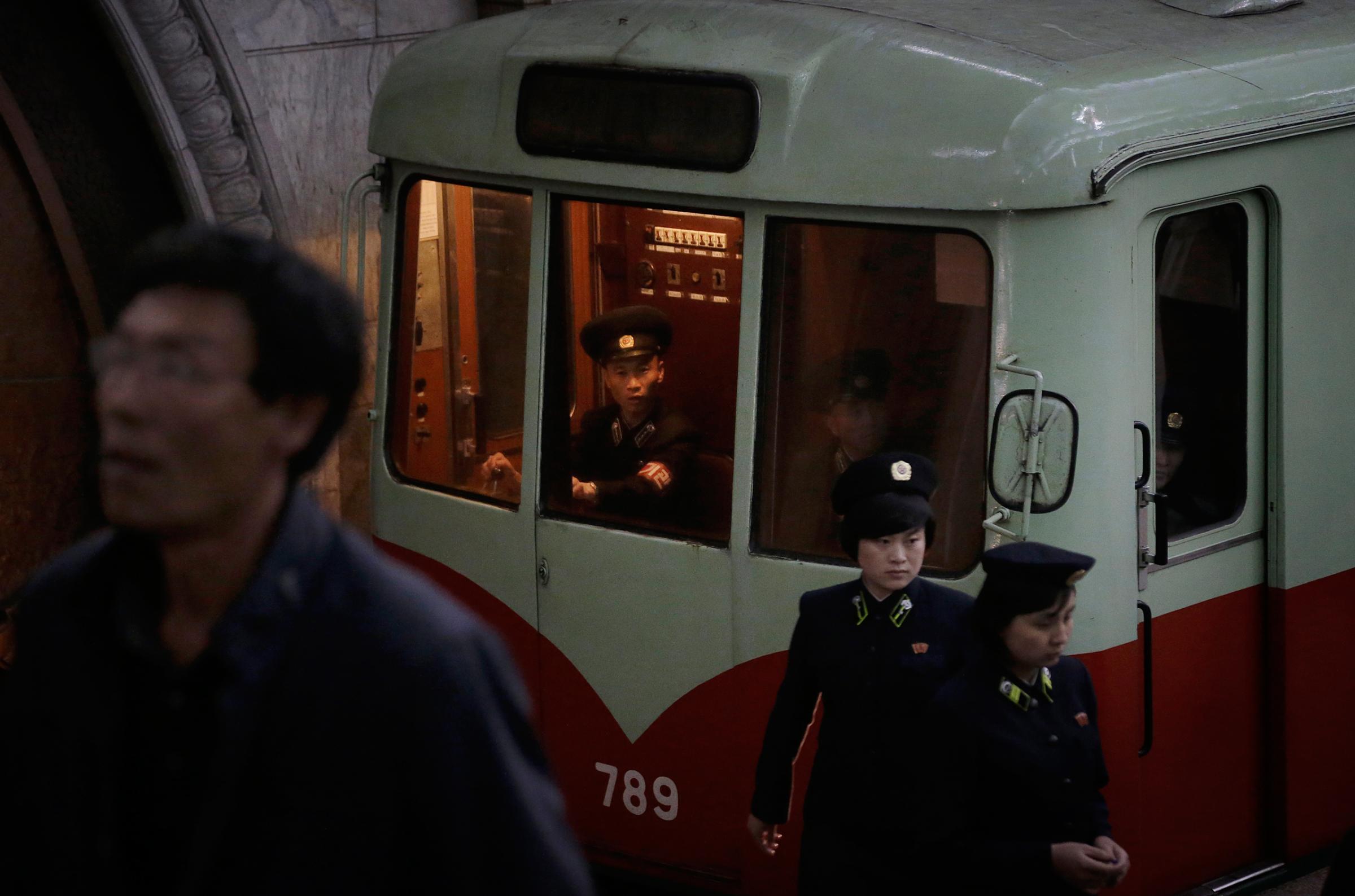 A train conductor and station attendants work in a subway station as seen during a press tour on Saturday, May 7, 2016, in Pyongyang, North Korea. North Korea's ruling party is preparing to bestow its top title on leader Kim Jong Un, another clear sign that the third heir to North Korea's dynasty of Kims is firmly in control despite his country's deepening international isolation over one of his key ambitions, to keep developing more and better nuclear weapons. (AP Photo/Wong Maye-E)