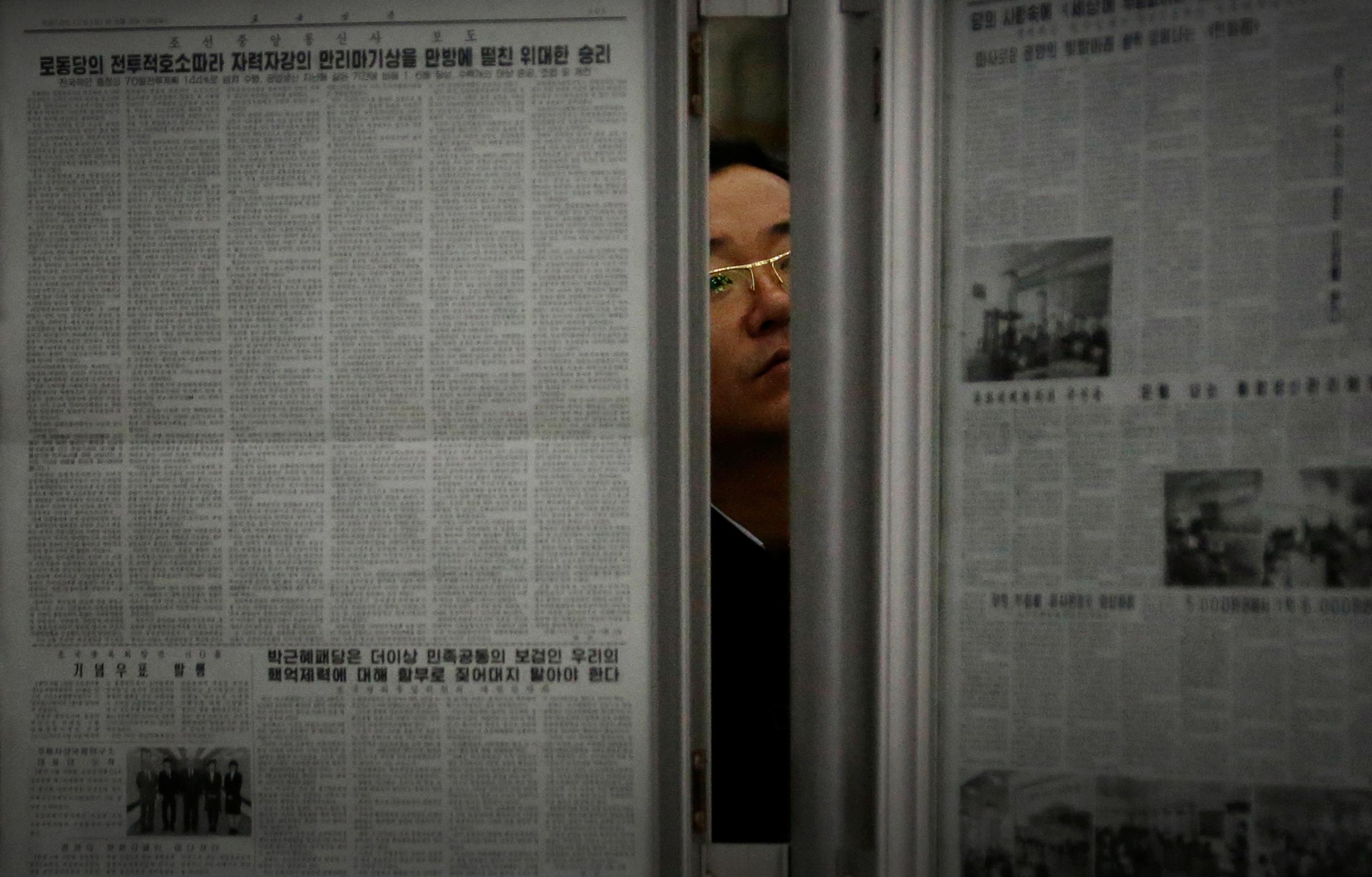 A North Korean man reads the local newspapers displayed in a subway station as seen during a press tour on Saturday, May 7, 2016, in Pyongyang, North Korea. North Korea's ruling party is preparing to bestow its top title on leader Kim Jong Un, another clear sign that the third heir to North Korea's dynasty of Kims is firmly in control despite his country's deepening international isolation over one of his key ambitions, to keep developing more and better nuclear weapons. (AP Photo/Wong Maye-E)