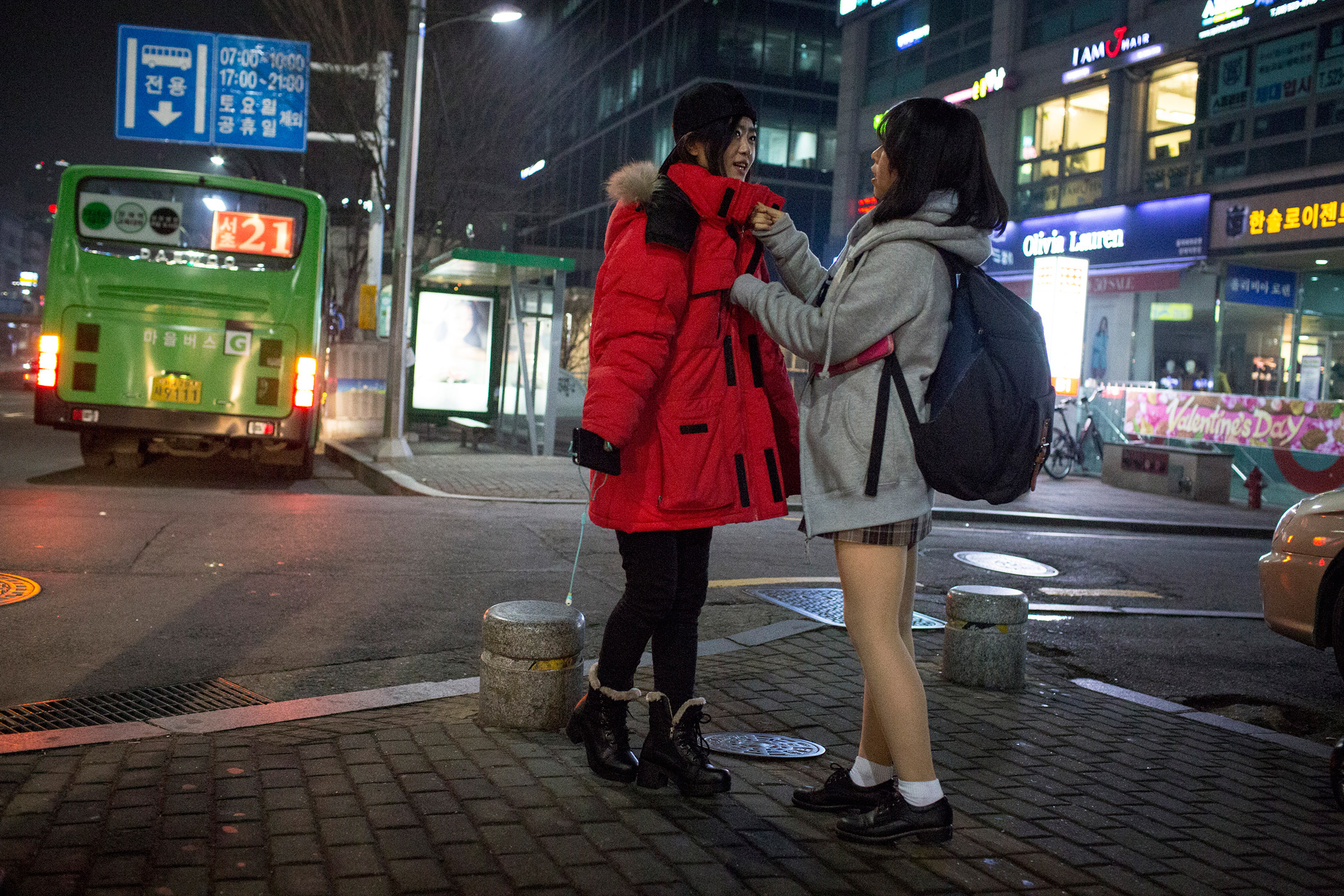 Kyong-ok zips up Sarah's jacket, which she borrowed from her brother, during a night out Feb. 4, 2015 in Seoul, South Korea. The community of North Korean refugees is growing smaller and more tight knit with the help of social networks and human rights groups. Caitlin O'Hara