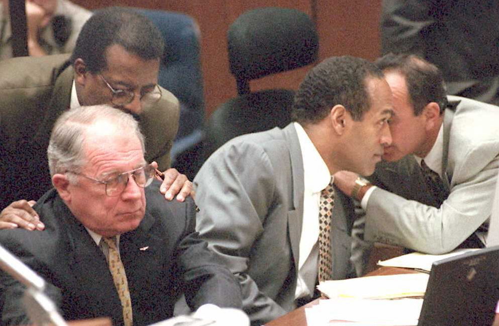Defense attorney Johnnie Cochran Jr. (2nd-L) confers with F. Lee Bailey (L) as O.J. Simpson(2nd-R) confers with Robert Shapiro (R) during morning testimony 20 June in the O.J. Simpson double murder trial. Simpson is being charged with the double murders of Nicole Brown Simpson and Ronald Goldman.