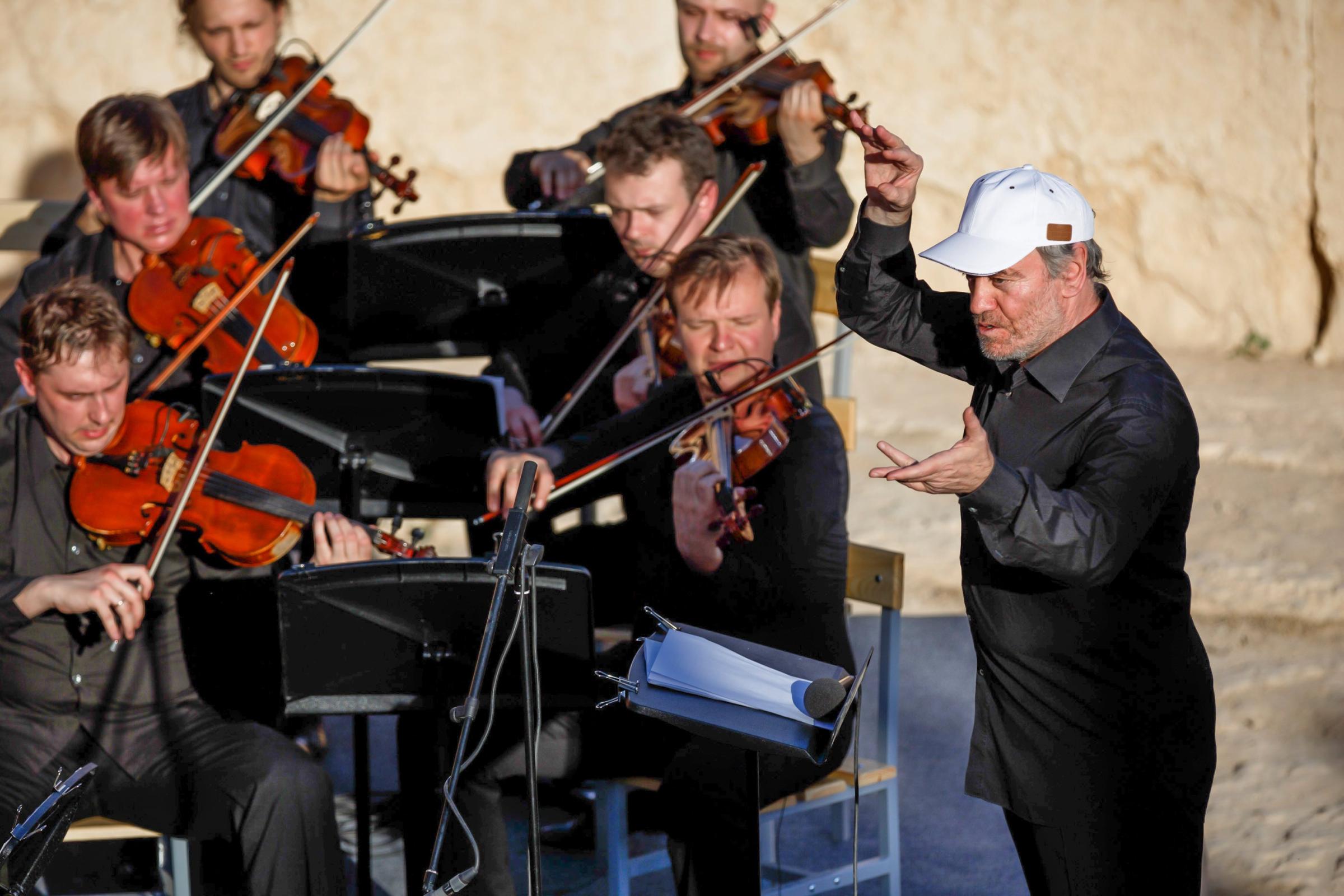 In this photo released by Russian Ministry of Defence, conductor Valery Gergiev leads a concert by the Mariinsky Theater Orchestra in the Palmyra amphitheater in Syria, on May 5, 2016.