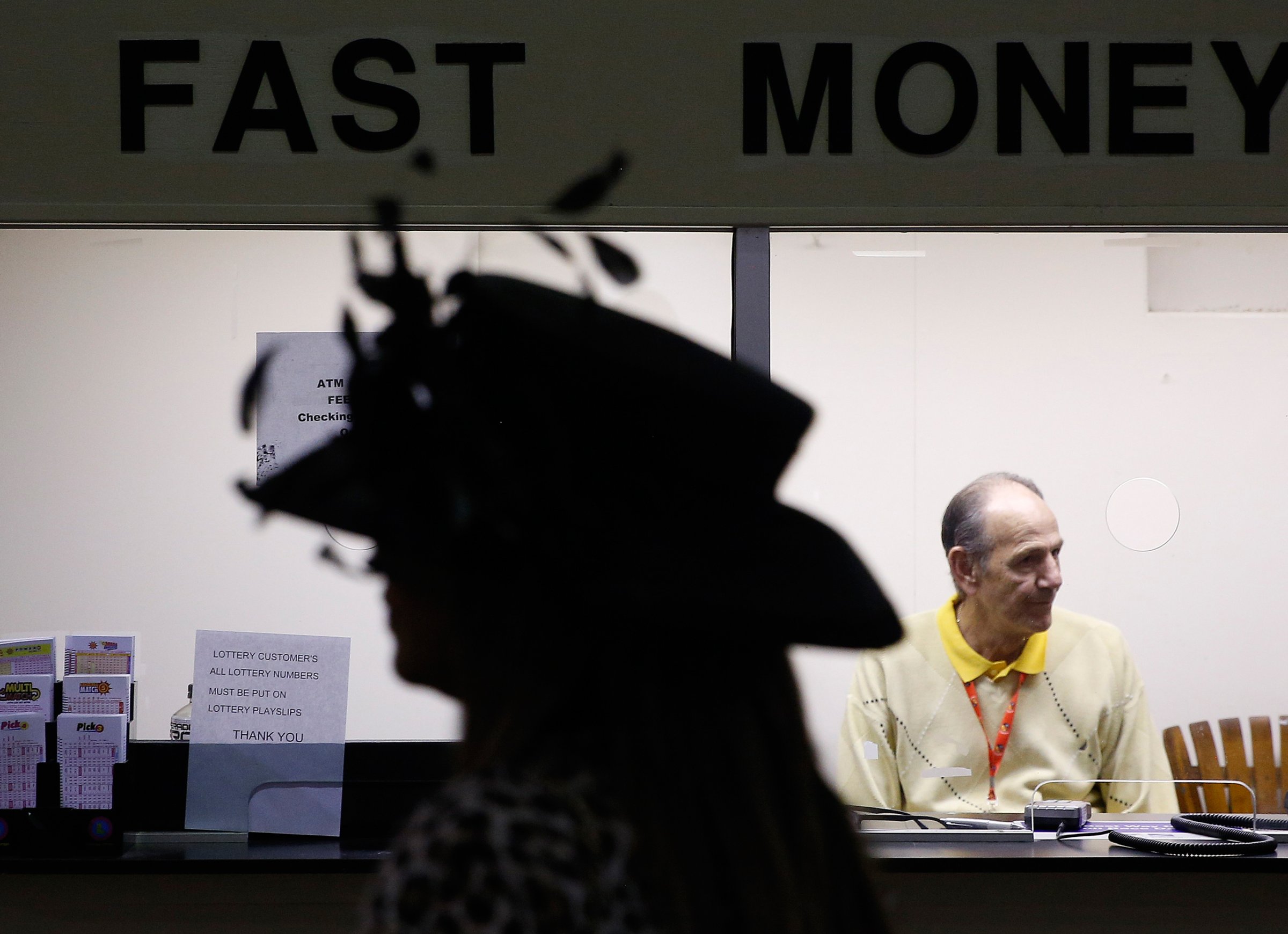 A woman passes a counter ahead of the 141st Preakness Stakes horse race at Pimlico Race Course, Saturday, May 21, 2016, in Baltimore. (AP Photo/Patrick Semansky)
