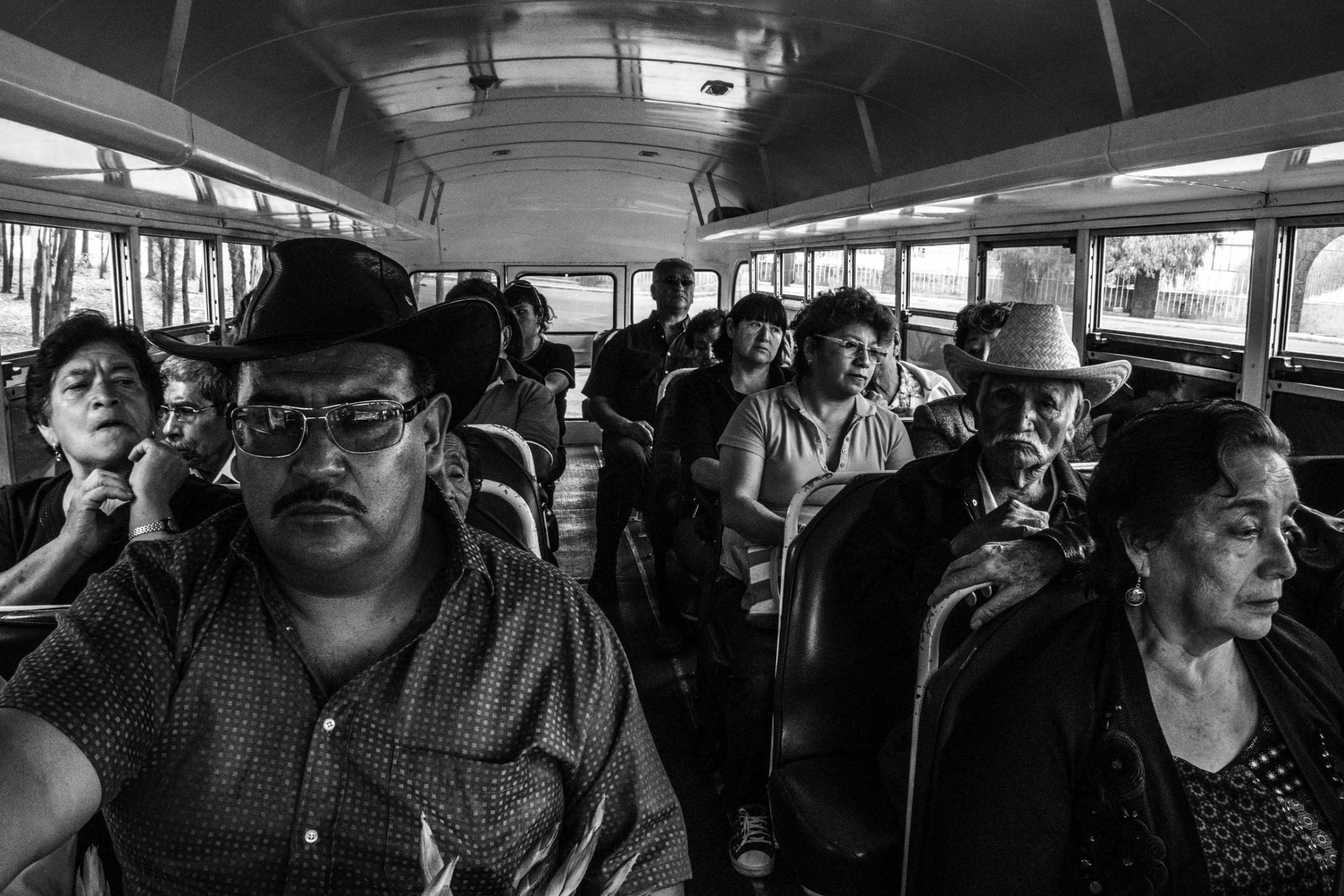 A low income family is going by bus trough the San Lorenzo Tezonco cemetary, to assist at the funerals of one of their family member. Itzapalapa, Mexico City, Mexico on March 17, 2016.