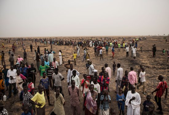 Tens of thousands of South Sudanese line up for food handouts on March 17. The fighting has left many in the country starving