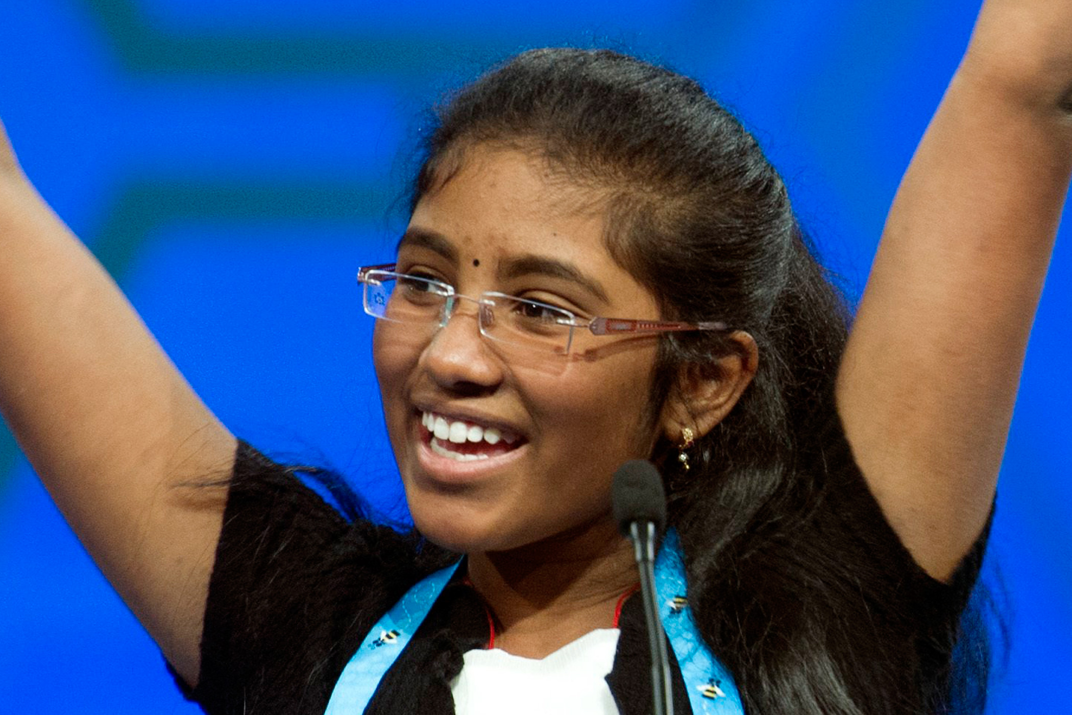 Asritha Sure, 13, of Morgantown, W. Va. celebrates correctly spelling her word during a preliminary round of the Scripps National Spelling Bee in National Harbor, Md., May 25, 2016.