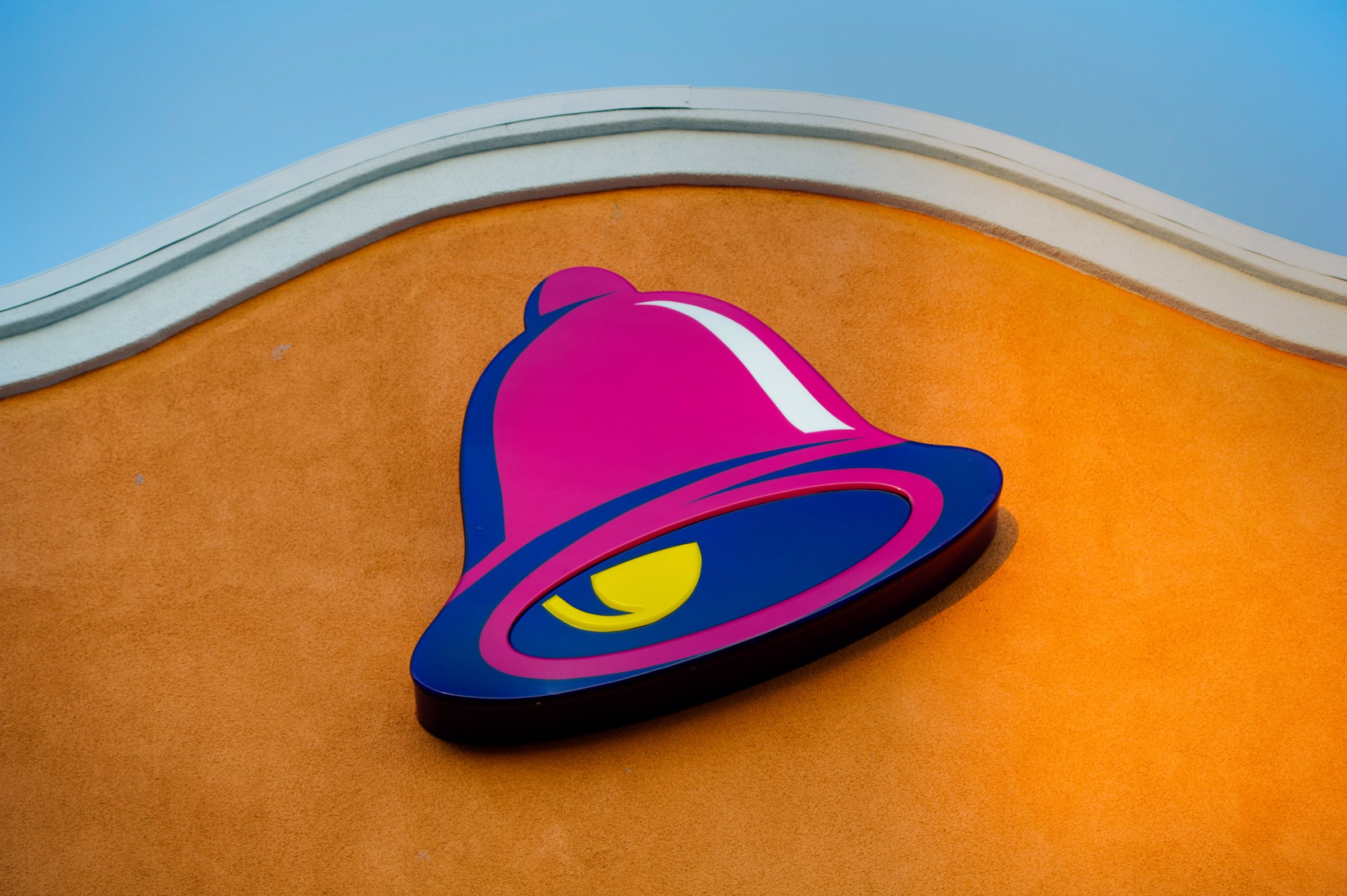 The logo for Taco Bell, a unit of Yum! Brands Inc., is displayed outside of a restaurant in Daly City, California, U.S., on Friday, April 18, 2014. Yum! Brands Inc. is expected to release earnings figures on April 22. Photographer: David Paul Morris/Bloomberg via Getty Images