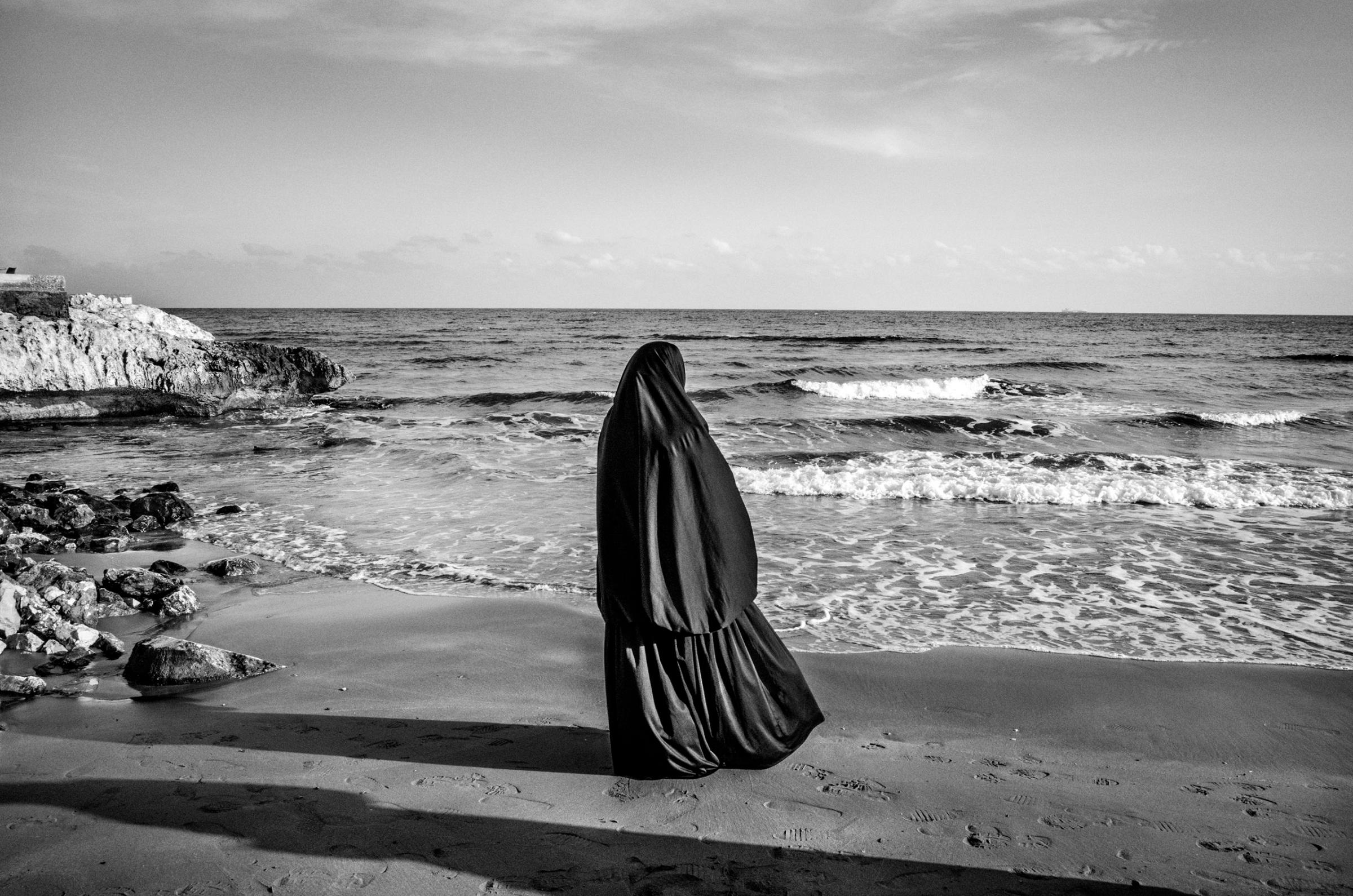 A Syrian woman looks at the sea in Kizkalesi, Turkey, while waiting to board a ship heading further north in Europe, Jan. 29, 2015. More than 3,000 refugees and migrants drowned in the Mediterranean in 2014 fleeing conflict-torn regions, and more than 3,700 died in 2015.