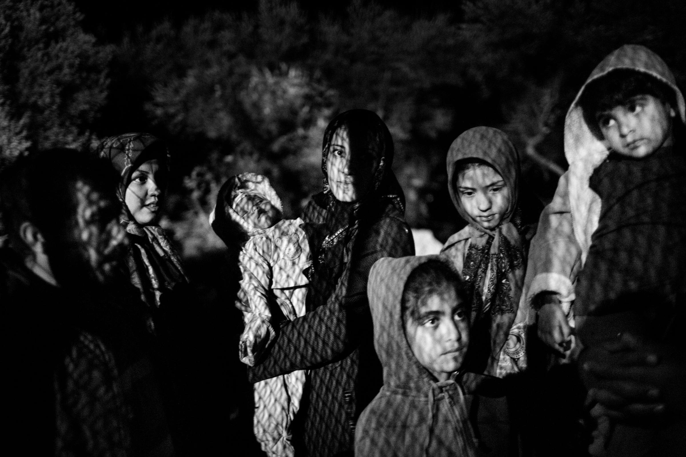 Afghan refugees wait to be registered on the Greek island of Lesbos, Oct. 12, 2015.