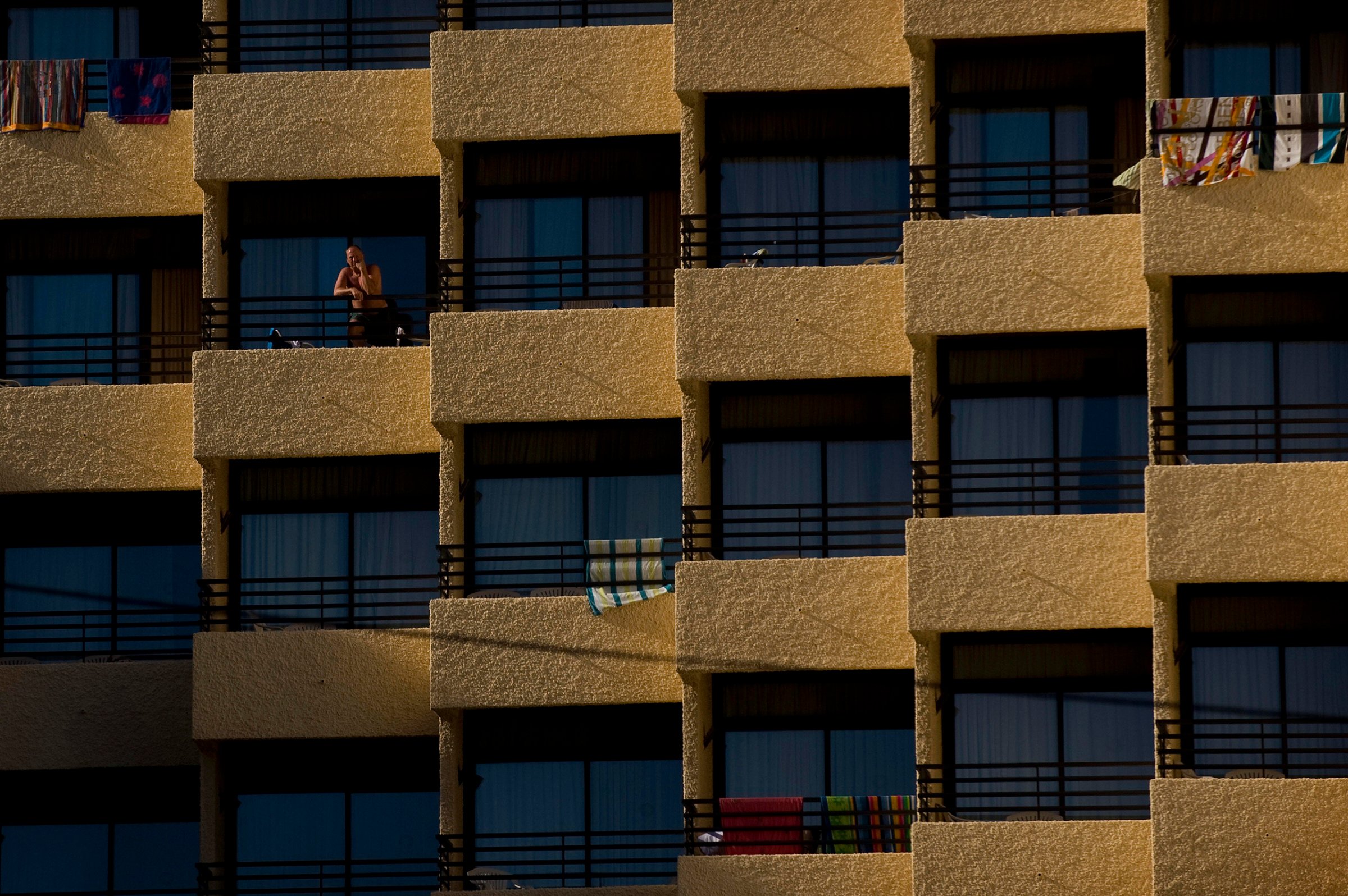 A man stands on the terrace of a hotel in Torremolinos, southern Spain, Aug. 3, 2009.