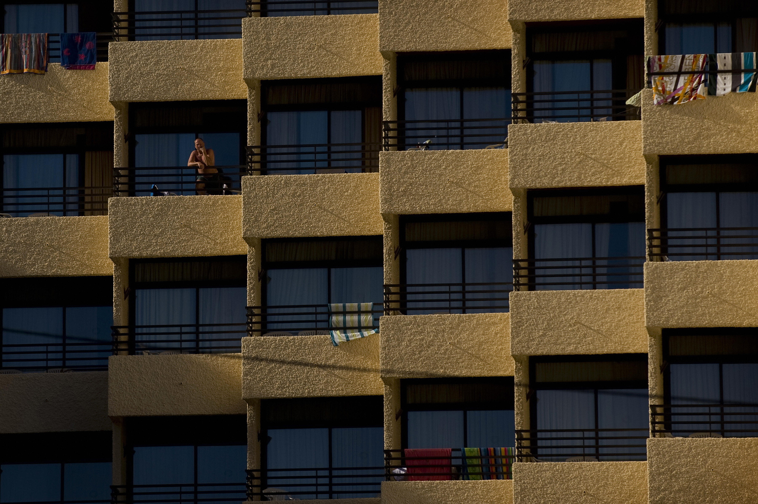 A man stands on the terrace of a hotel in Torremolinos, southern Spain, Aug. 3, 2009. (Jorge Guerrero—AFP/Getty Images)