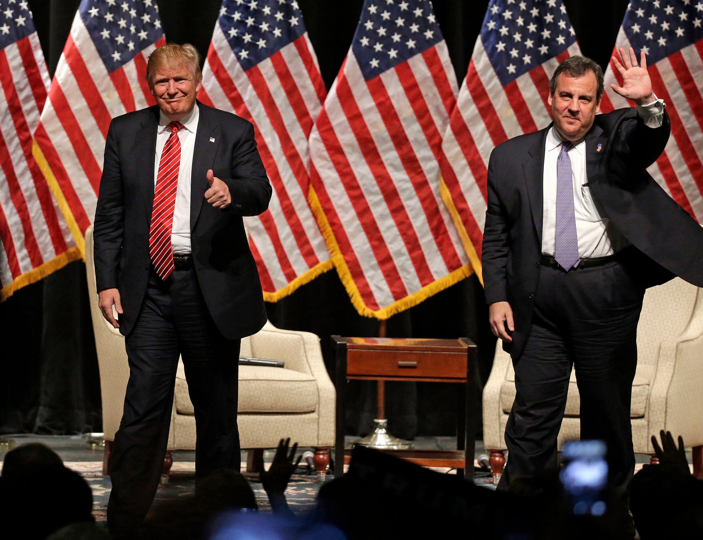 Donald Trump gives a thumbs up as New Jersey Gov. Chris Christie waves to the crowd as they walk off the stage after a rally at Lenoir-Rhyne University in Hickory, N.C., March 14, 2016.