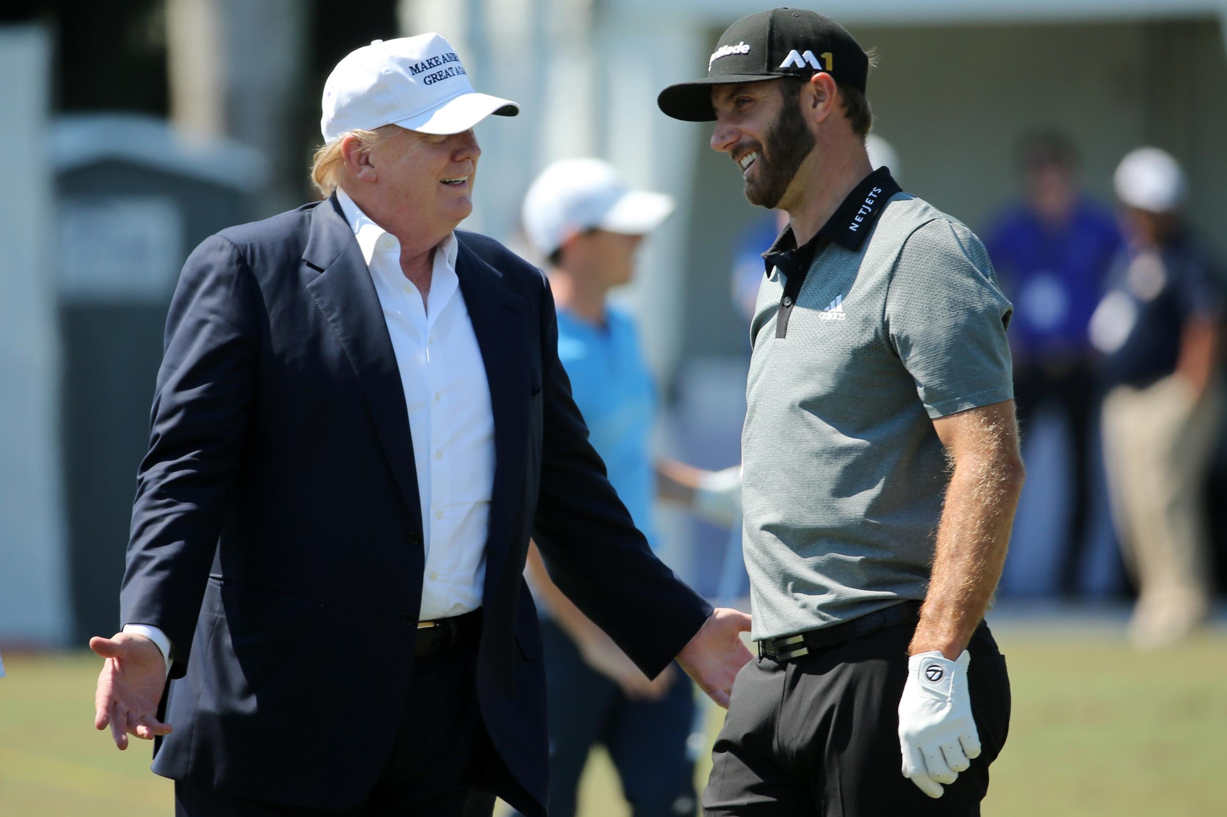 Donald Trump speaks with golfer Dustin Johnson at Trump National Doral Blue Monster Course on March 6, 2016 in Doral, Fla.