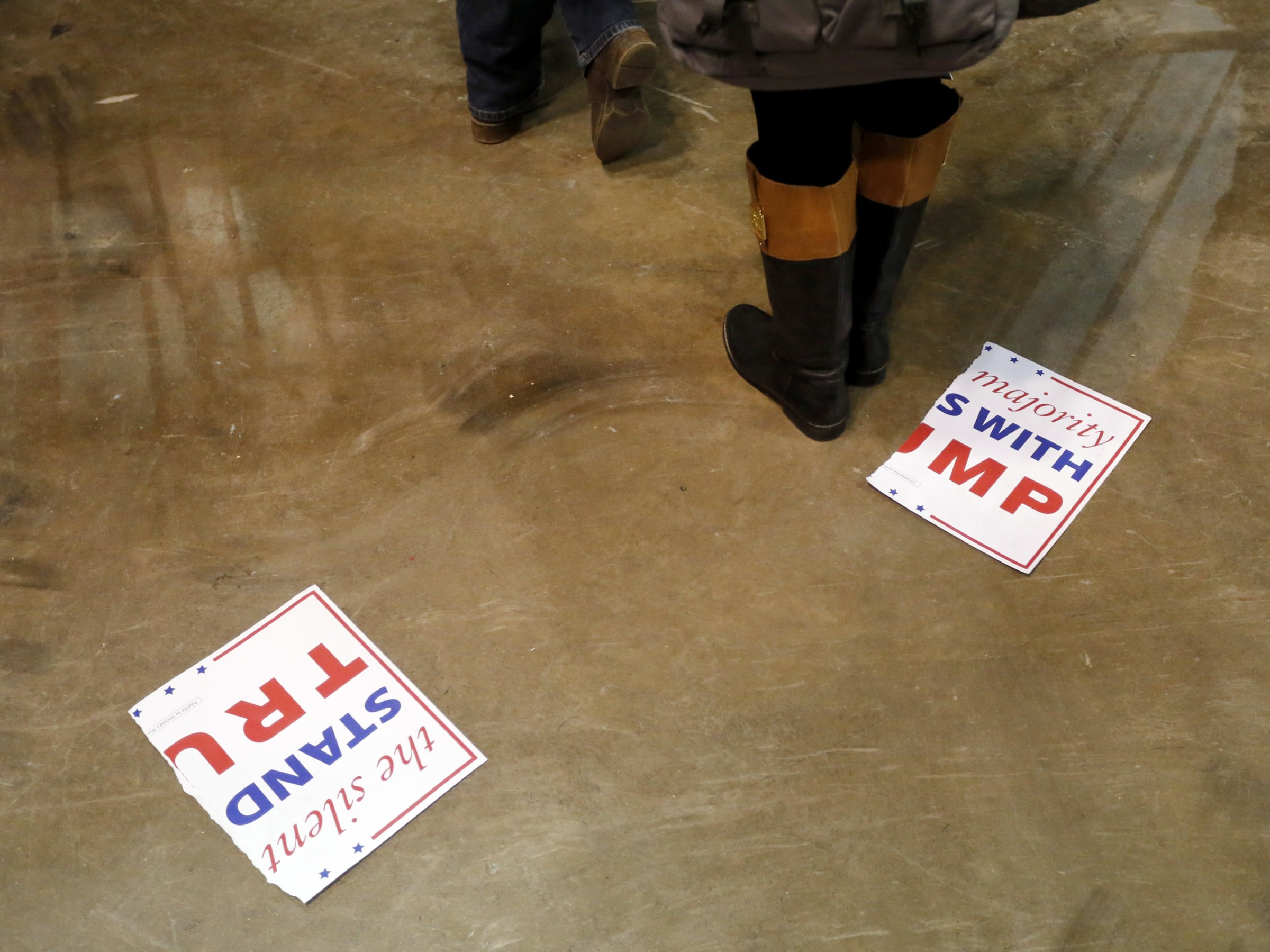 A torn campaign sign for Republican presidential candidate Donald Trump, lays on the floor after a rally for Trump was canceled due to security concerns, on the campus of the University of Illinois-Chicago, Friday, March 11, 2016, in Chicago. (AP Photo/Charles Rex Arbogast)