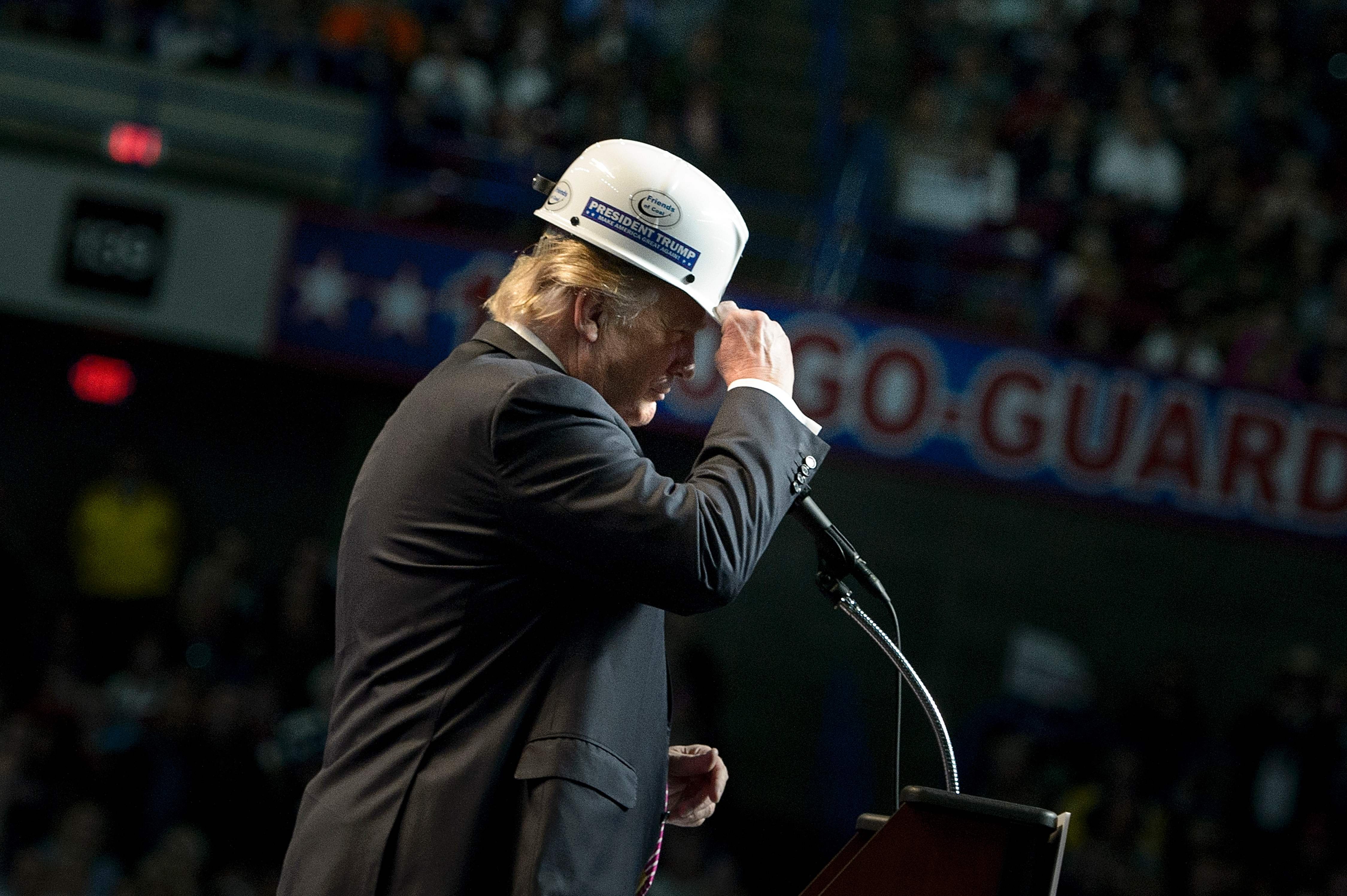 Donald Trump puts on a miner's hat while speaking during a rally on May 5, 2016 in Charleston, West Virginia. (Brendan Smialowski—AFP/Getty Images)