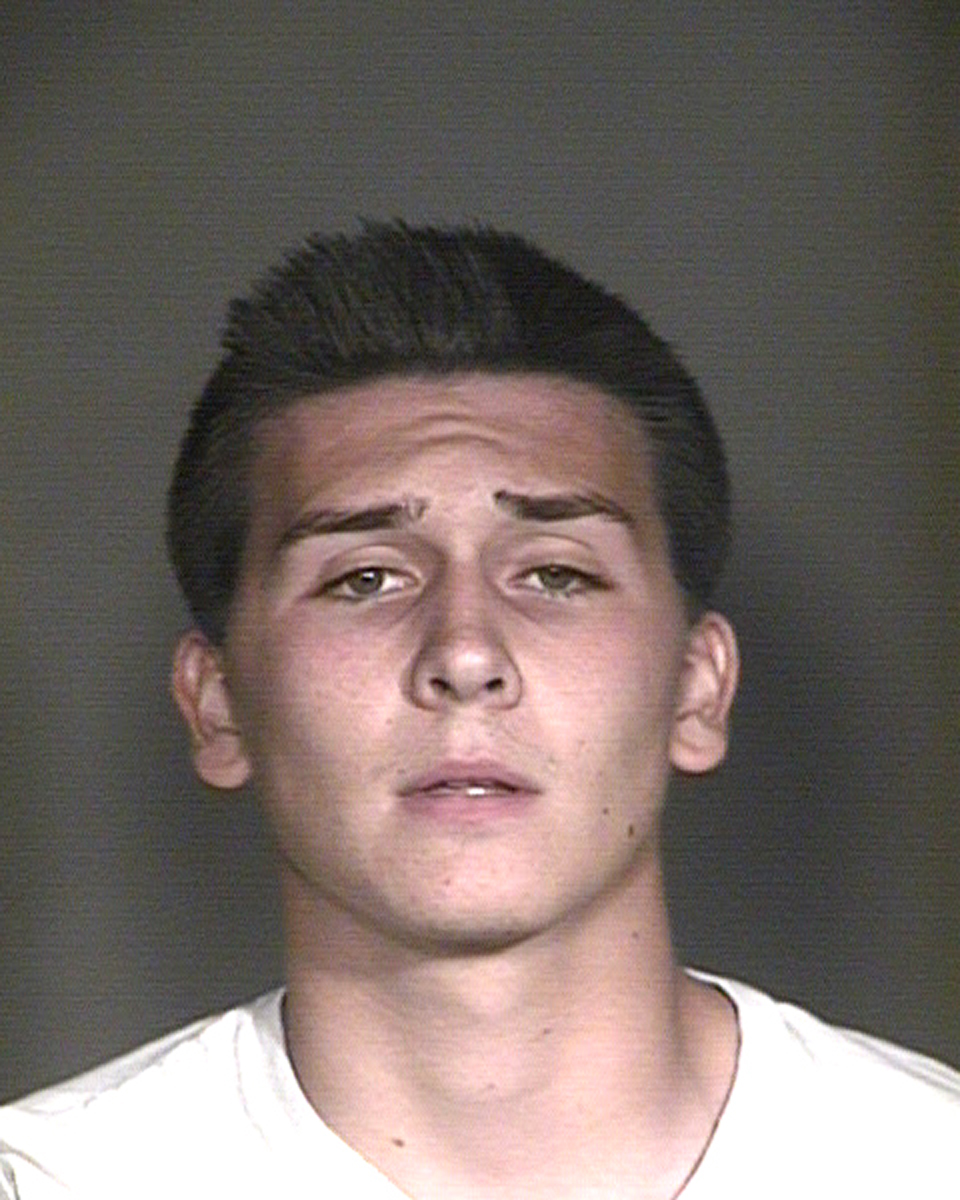 This undated booking photo provided by the Mesa Police Department, in Mesa, Ariz., shows Hunter Osborn. The Arizona high school student is facing dozens of charges after police say he exposed himself in a football team picture that ended up in a yearbook handed out to some 3400 students. (Mesa Police Department via AP)