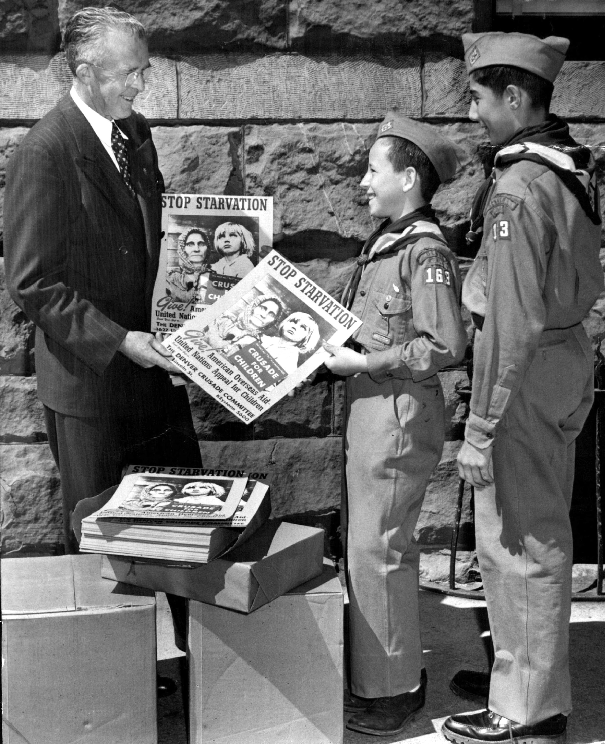 Denver Boy Scouts distributing posters to push campaign for aid to 230 million overseas children in desperate need of help. 1948.