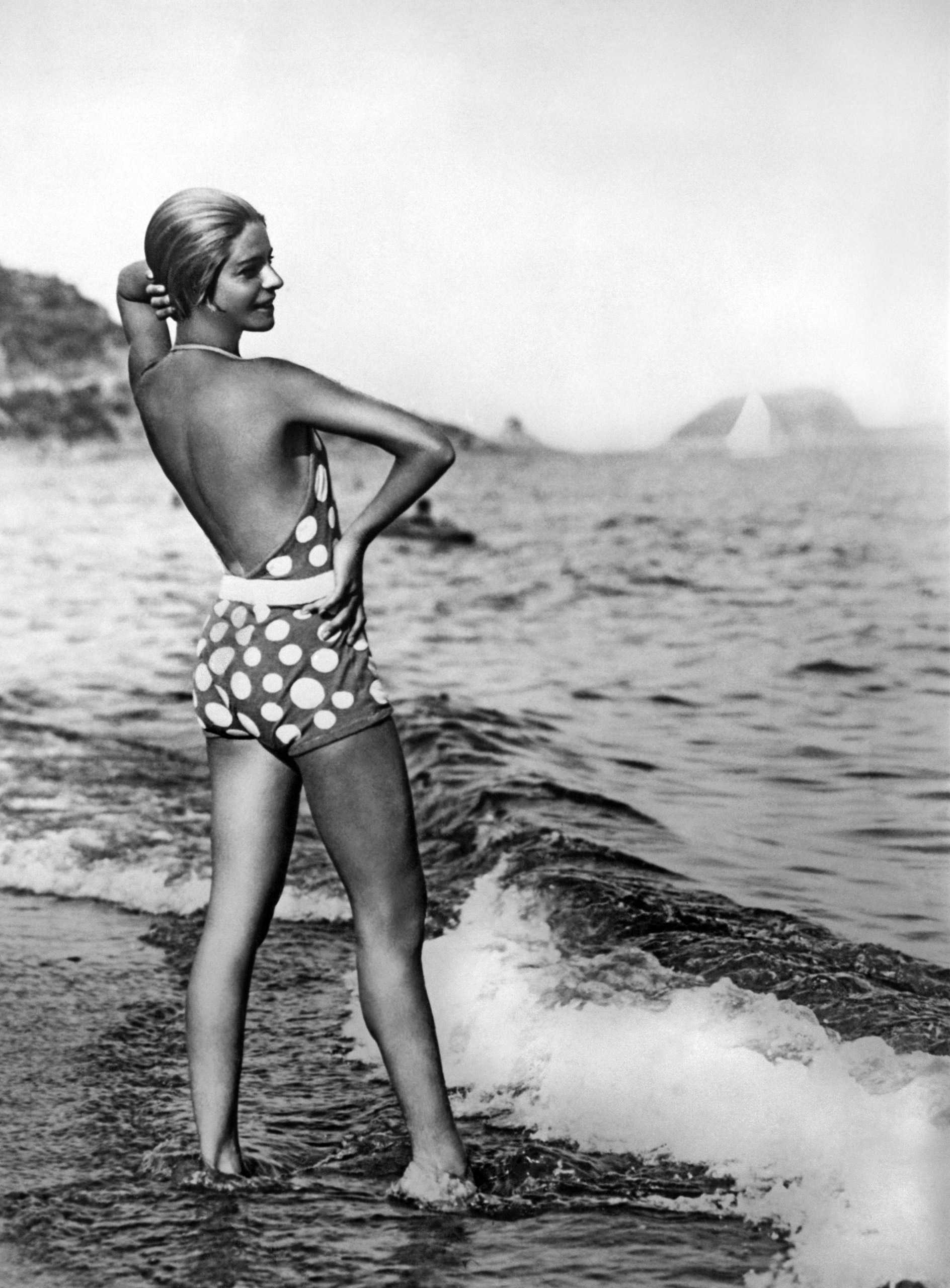 Alice Nikitina wearing a striking bathing suits at the beach in Italy, Alassio, Italy, circa 1929.