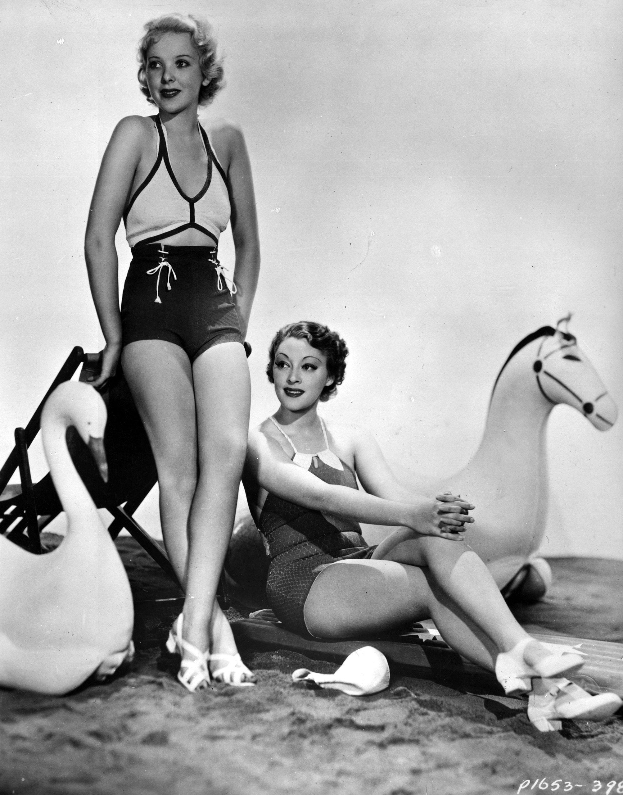 Actresses Ida Lupino and Kathleen Burke model the latest swimwear circa 1935