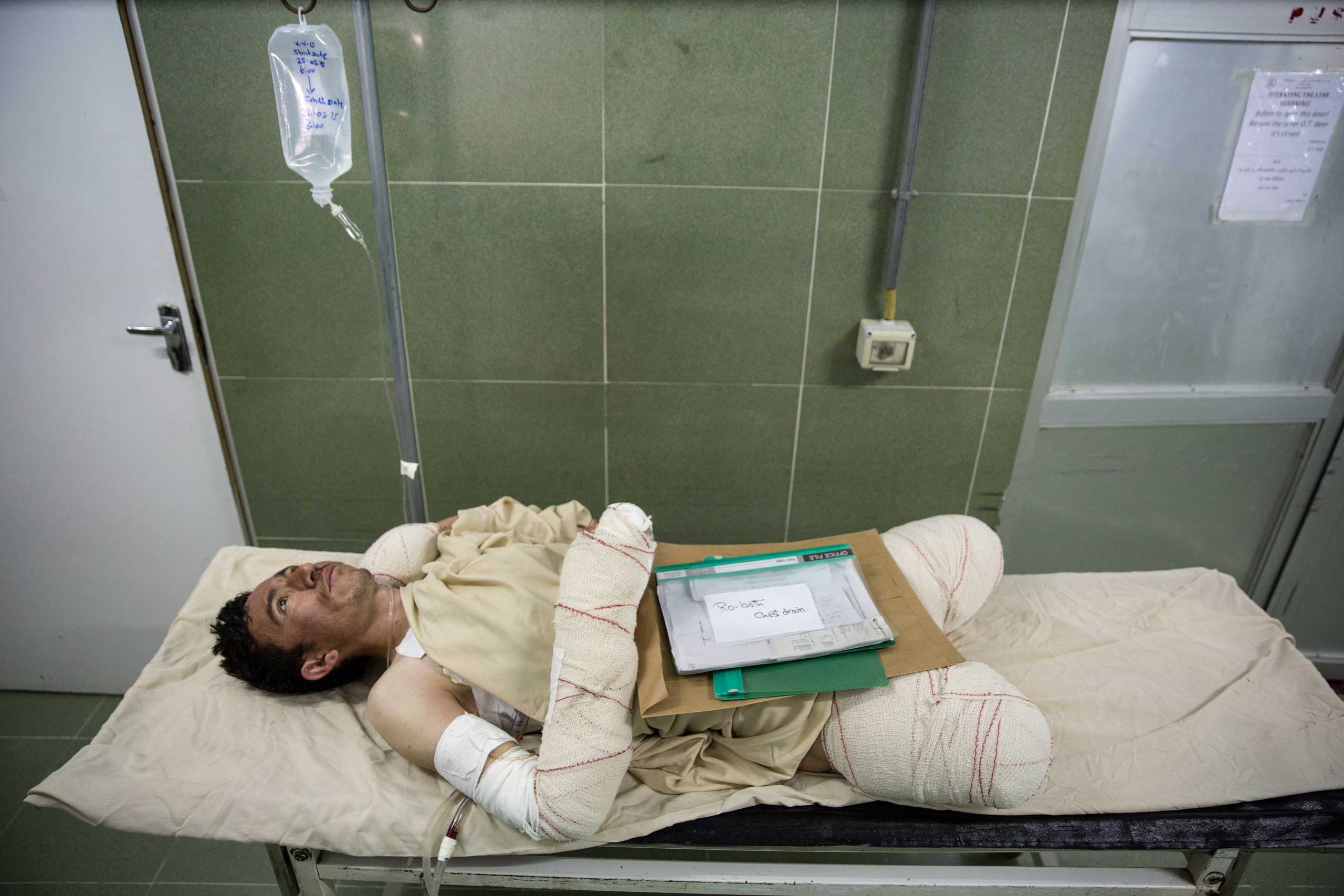 Sayed Malik, 25, waits to go into surgery. He lost his legs while demining, as a ANA soldier in Sangin. Lashkar Gah, Afghanistan on March 26, 2015.