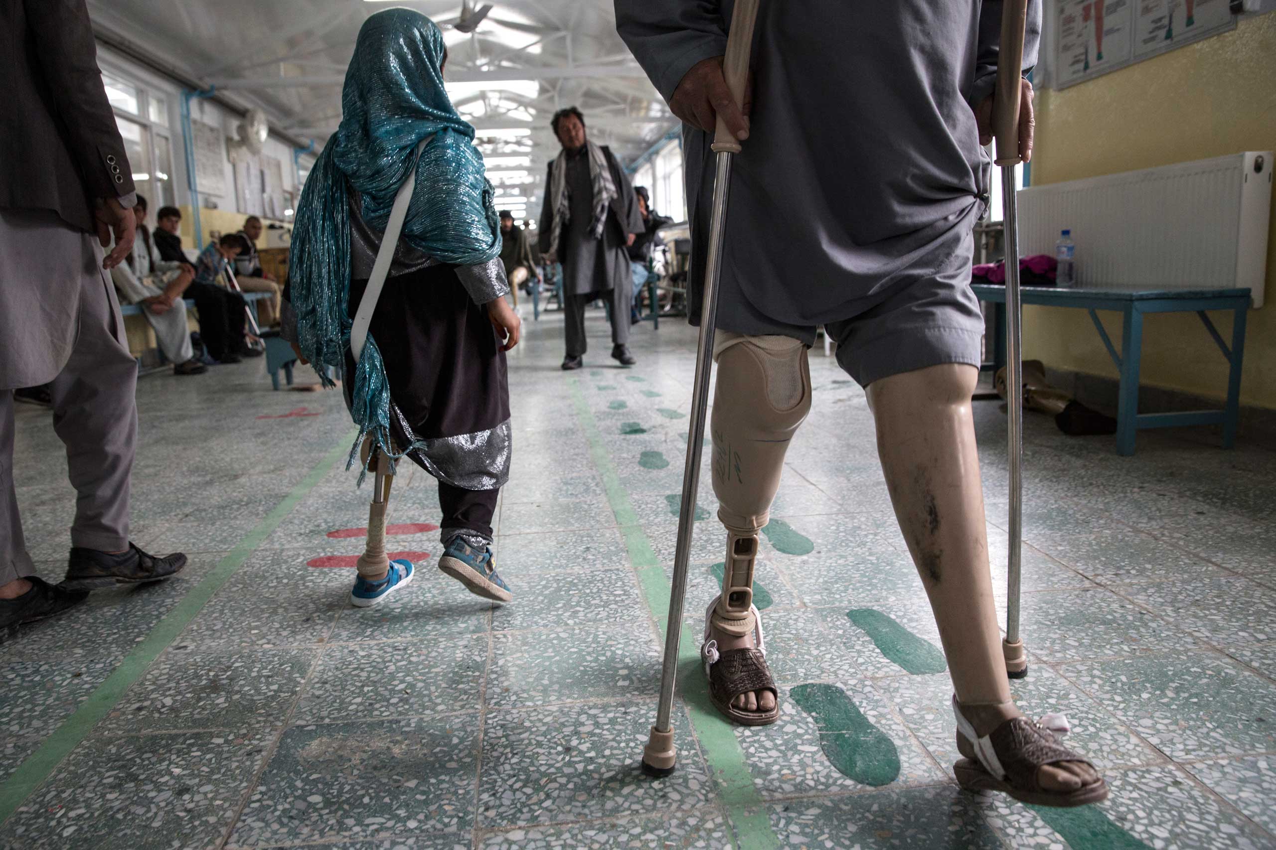 At the ICRC Orthopedic center, handicapped patients practice walking on their prosthetics in Kabul on April 2, 2016.
