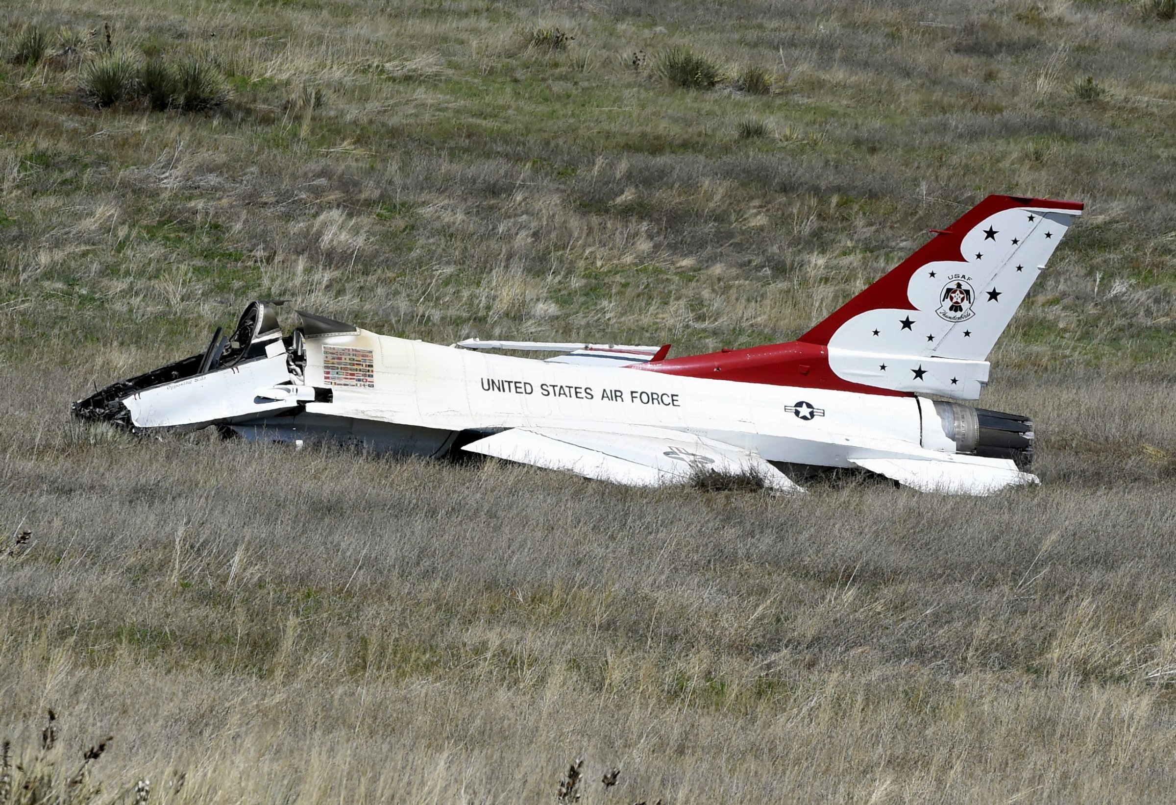 A U.S. Air Force Thunderbird that crashed following a flyover rests on the ground south of the Colorado Springs, Colo., airport after a performance at a commencement for Air Force Academy cadets Thursday, June 2, 2016. The pilot ejected safely from the jet. (Jerilee Bennett/The Gazette via AP) MAGS OUT; MANDATORY CREDIT