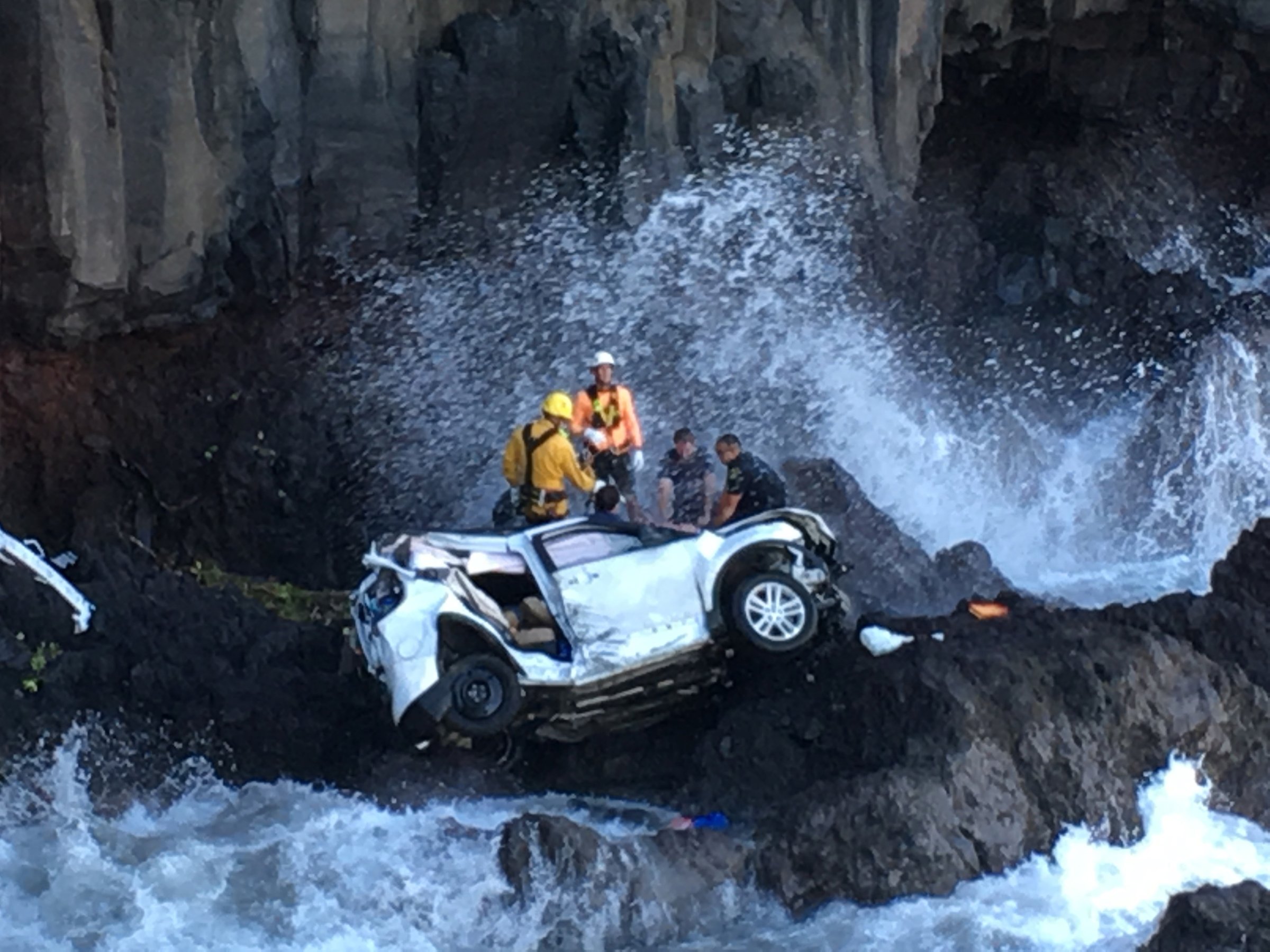 Rescue workers respond to the scene of a car crash off Maui’s Hana Highway in Hana, Hawaii on May 29, 2016.
