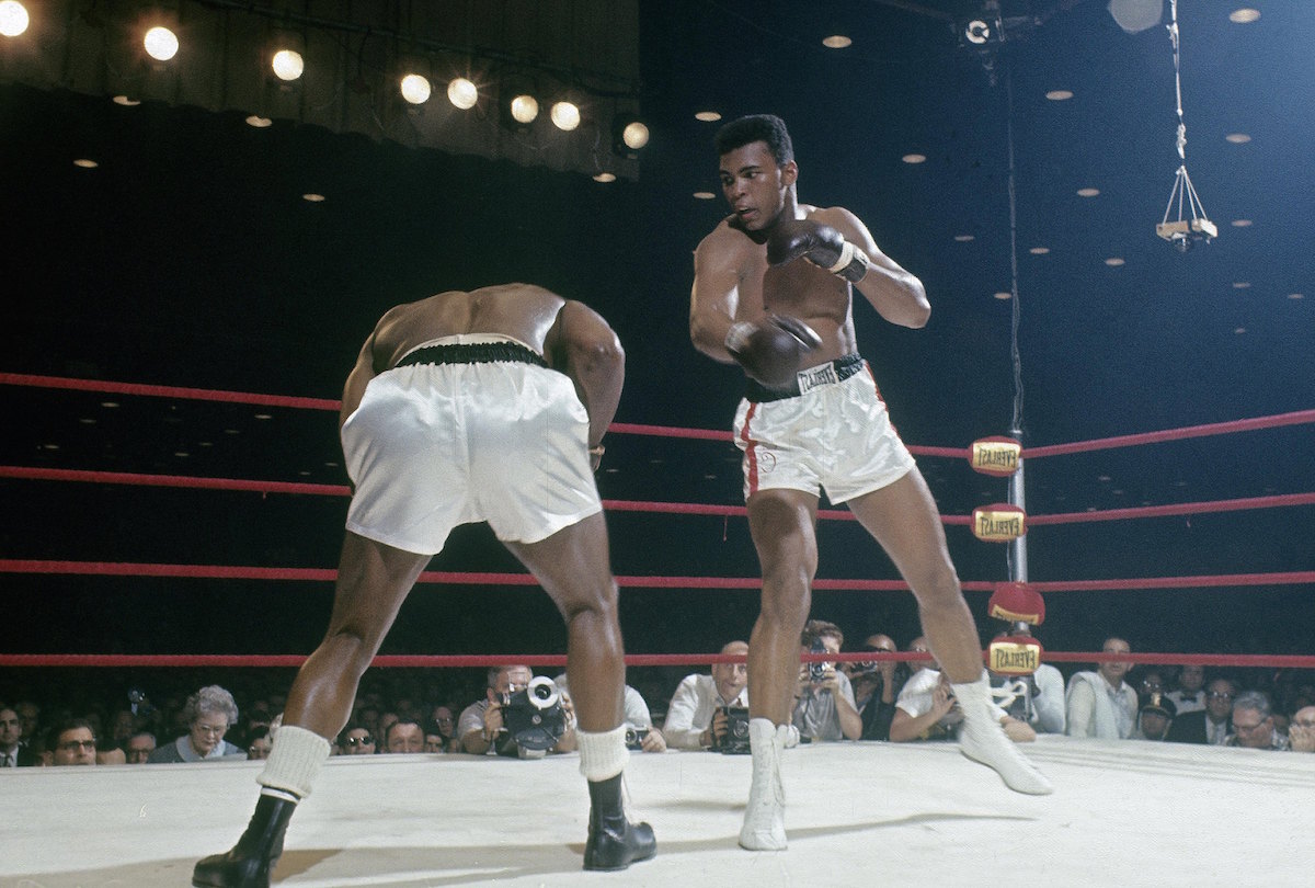 The boxer then known as Cassius Clay (R) throws a punch at Sonny Liston (L) in a World Heavyweight Title fight Feb. 25, 1964 at Convention Hall in Miami (Focus On Sport / Getty Images)
