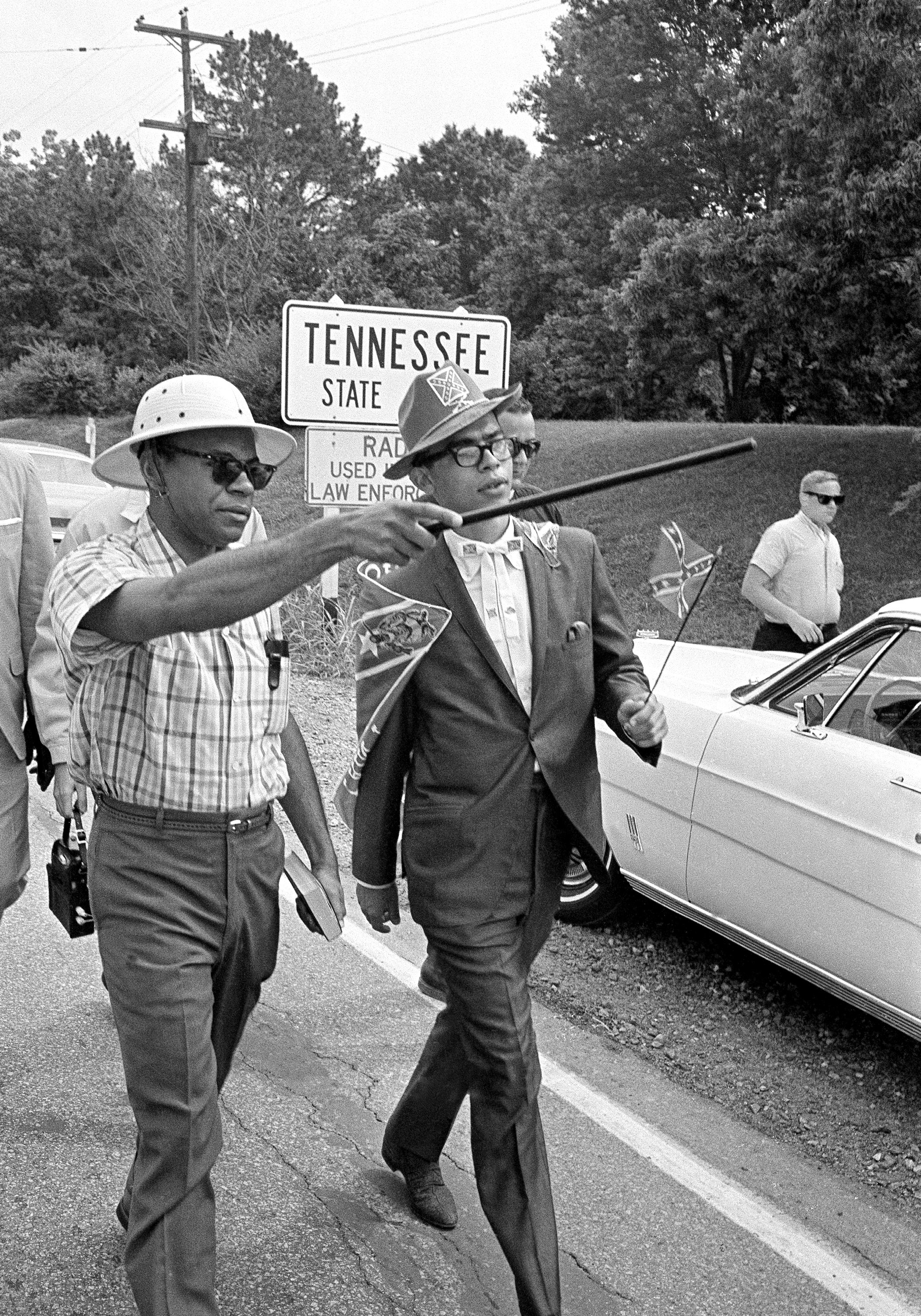 James H. Meredith, with sun helmet, points to the Mississippi state line with a walking cane as Meredith and several others crossed into Mississippi on the second day of a march to Jackson, Miss. on June 6, 1966. (AP)