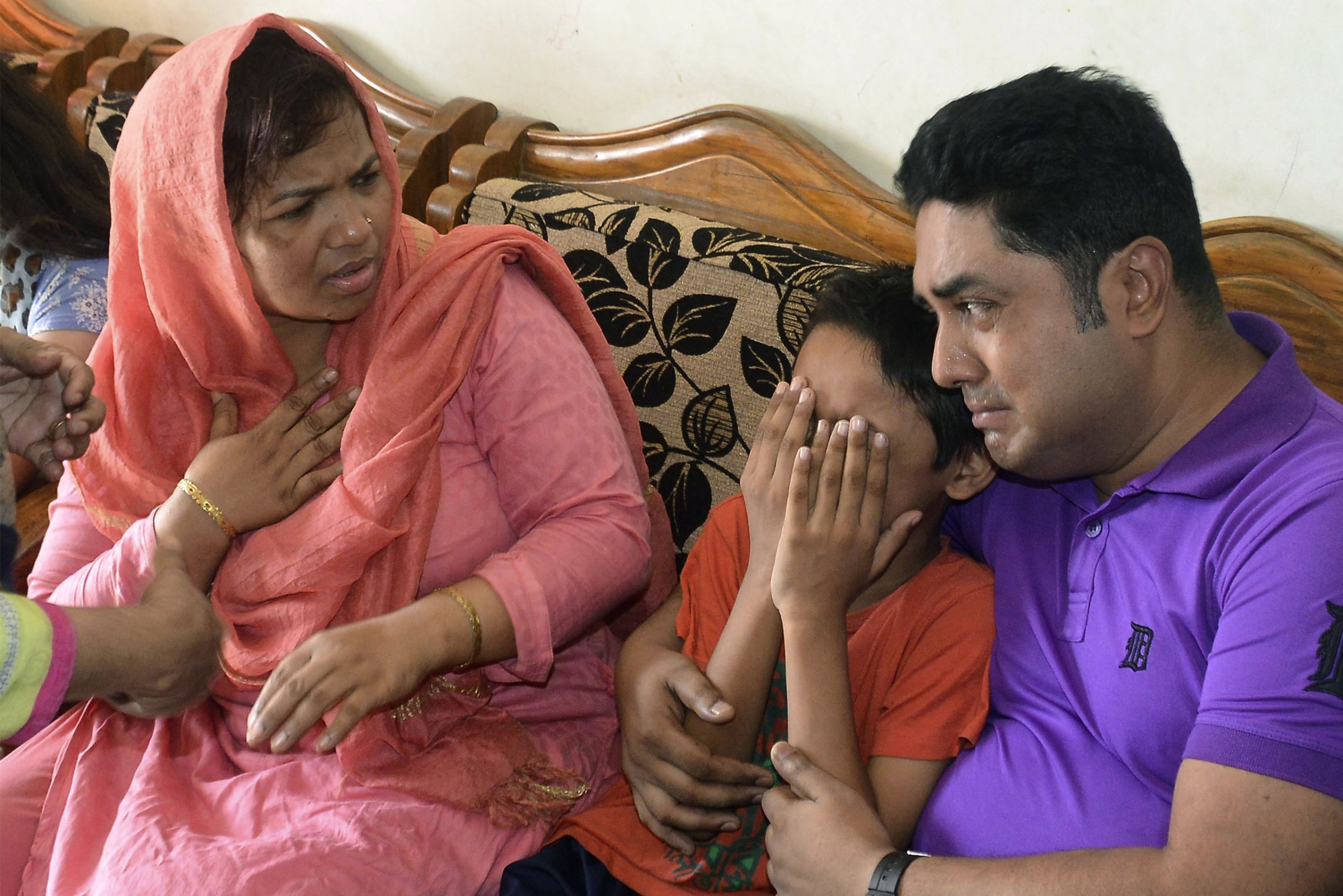 The young son of Mahmuda Aktar, the wife of a top Bangladeshi anti-terror officer, mourns after she was shot dead near her home in Chittagong on June 5, 2016. The wife of a top anti-terror officer was murdered in the southeastern city of Chittagong by suspected members of a banned local extremist group. / AFP / - (Photo credit should read -/AFP/Getty Images)