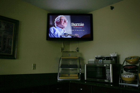 A campaign ad paid for by Democratic presidential candidate Sen. Bernie Sanders' campaign is shown on the TV in a hotel breakfast room November 16, 2015 in Des Moines, Iowa.