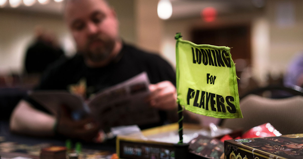 A man looks through instructions while playing a board game during the Cleveland Concoction March 11, 2016 in Cleveland, Ohio.