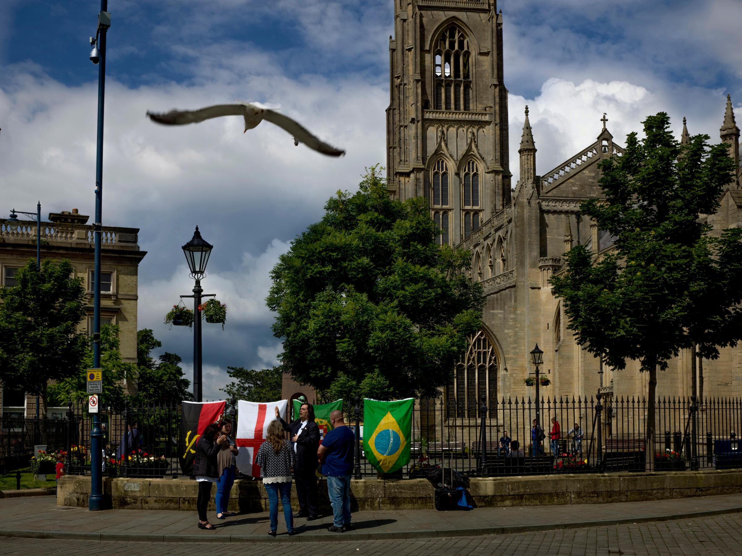 Members of a newly organized church group from Portugal and Brazil stand in Boston’s main square singing prayers. Boston, Lincolnshire, June 26, 2016.