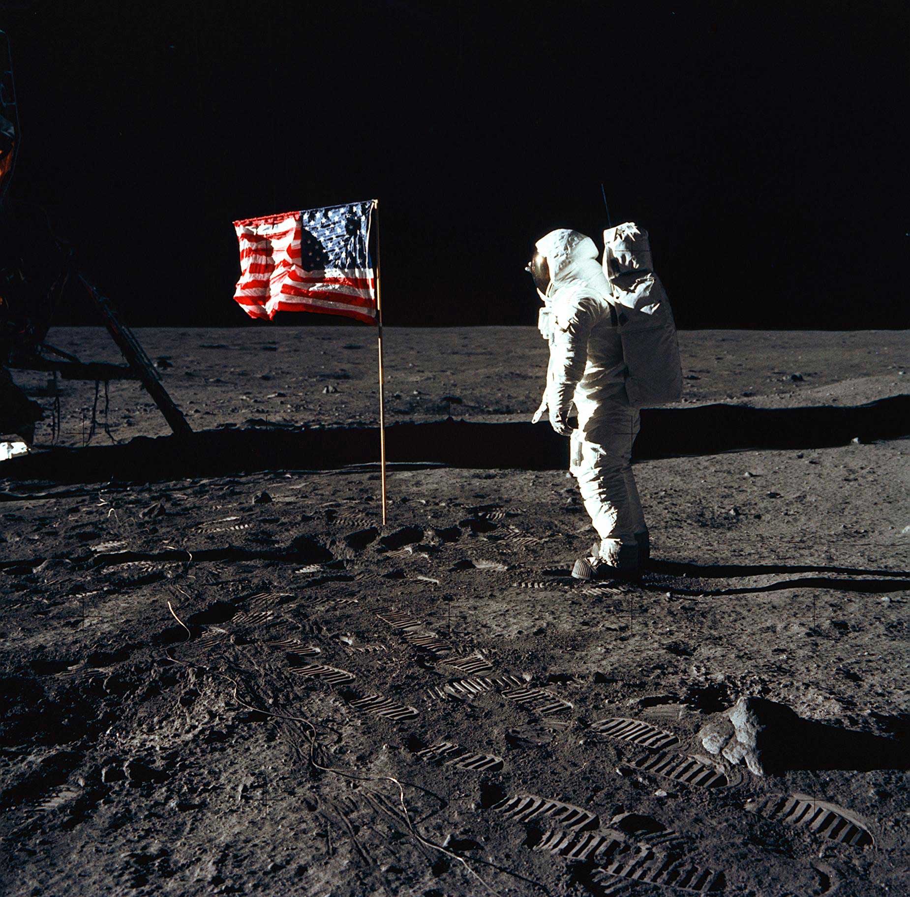 Astronaut Buzz Aldrin, lunar module pilot of the first lunar landing mission, poses for a photograph beside the deployed United States flag during an Apollo 11 Extravehicular Activity (EVA) on the lunar surface.